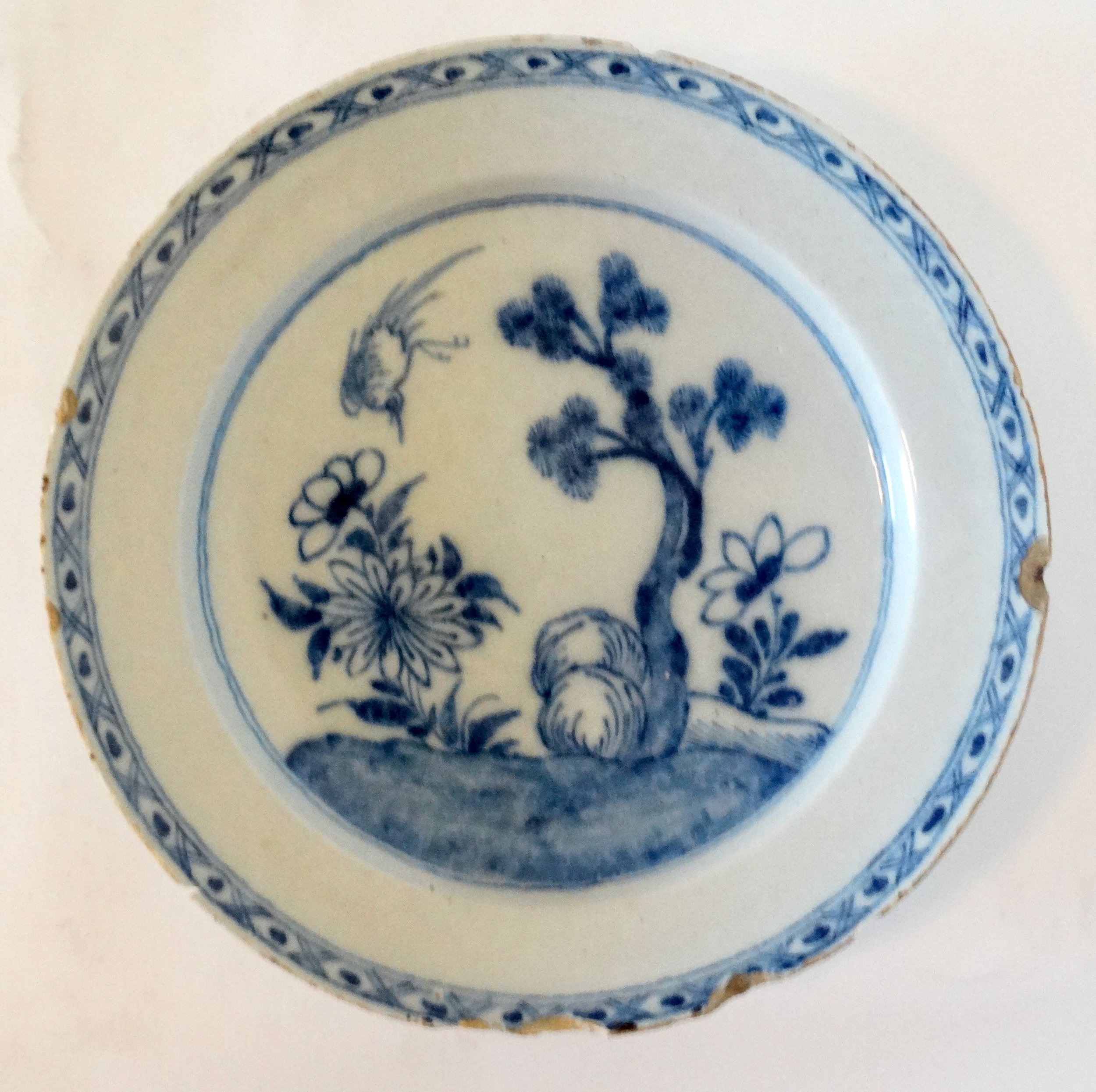 Large antique Delft chinoiserie charger with hand painted blue floral and tree design.