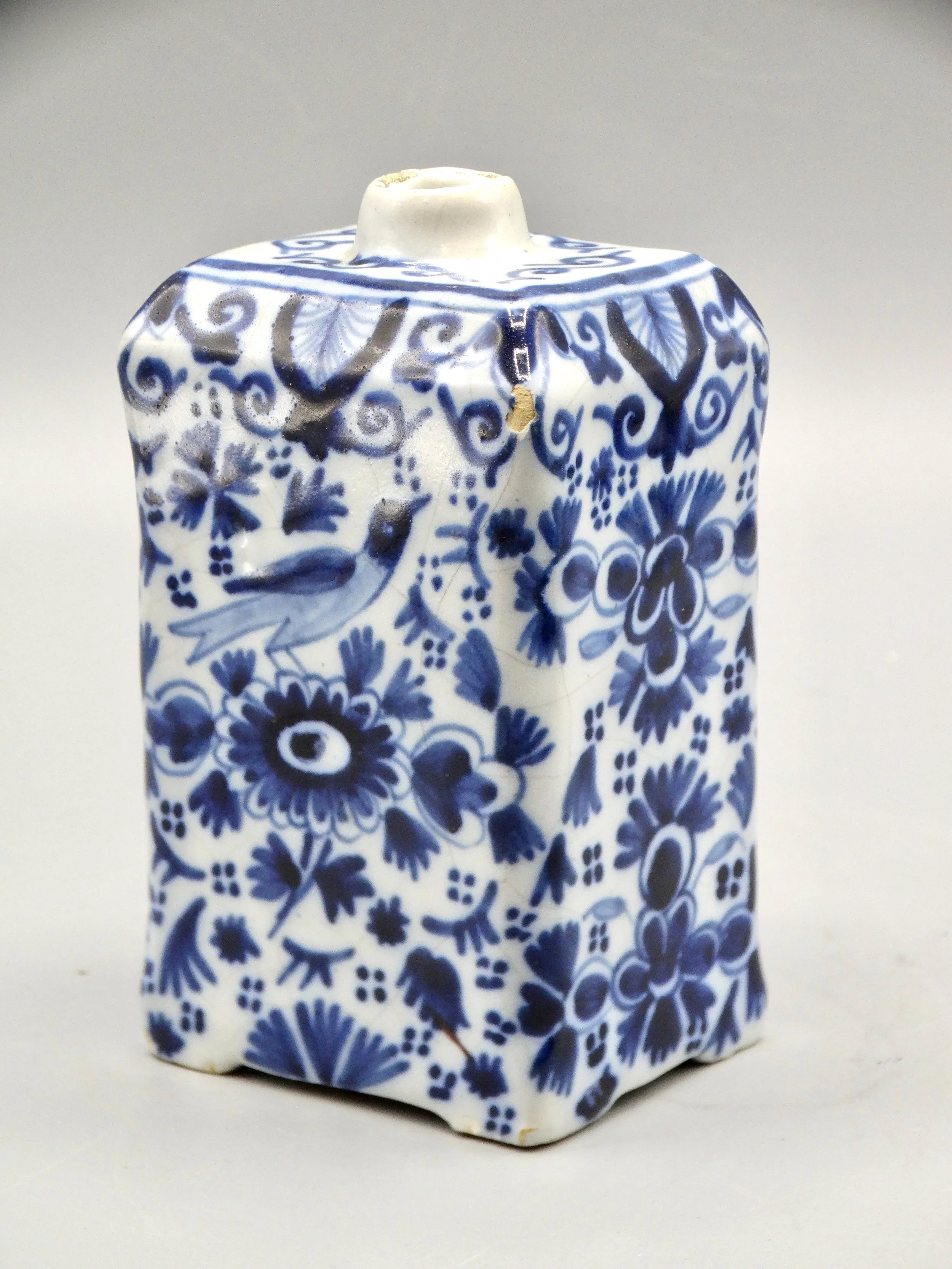 19th-century English Delft tea caddy with hand painted rampart lions, crown coat of arms, bird, and floral motifs.