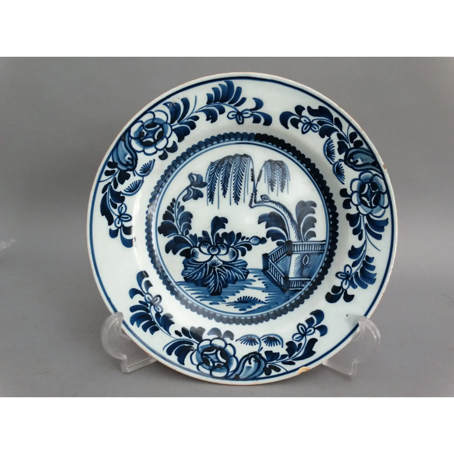 18th century Delft chinoiserie plate with willow tree in blue and white.