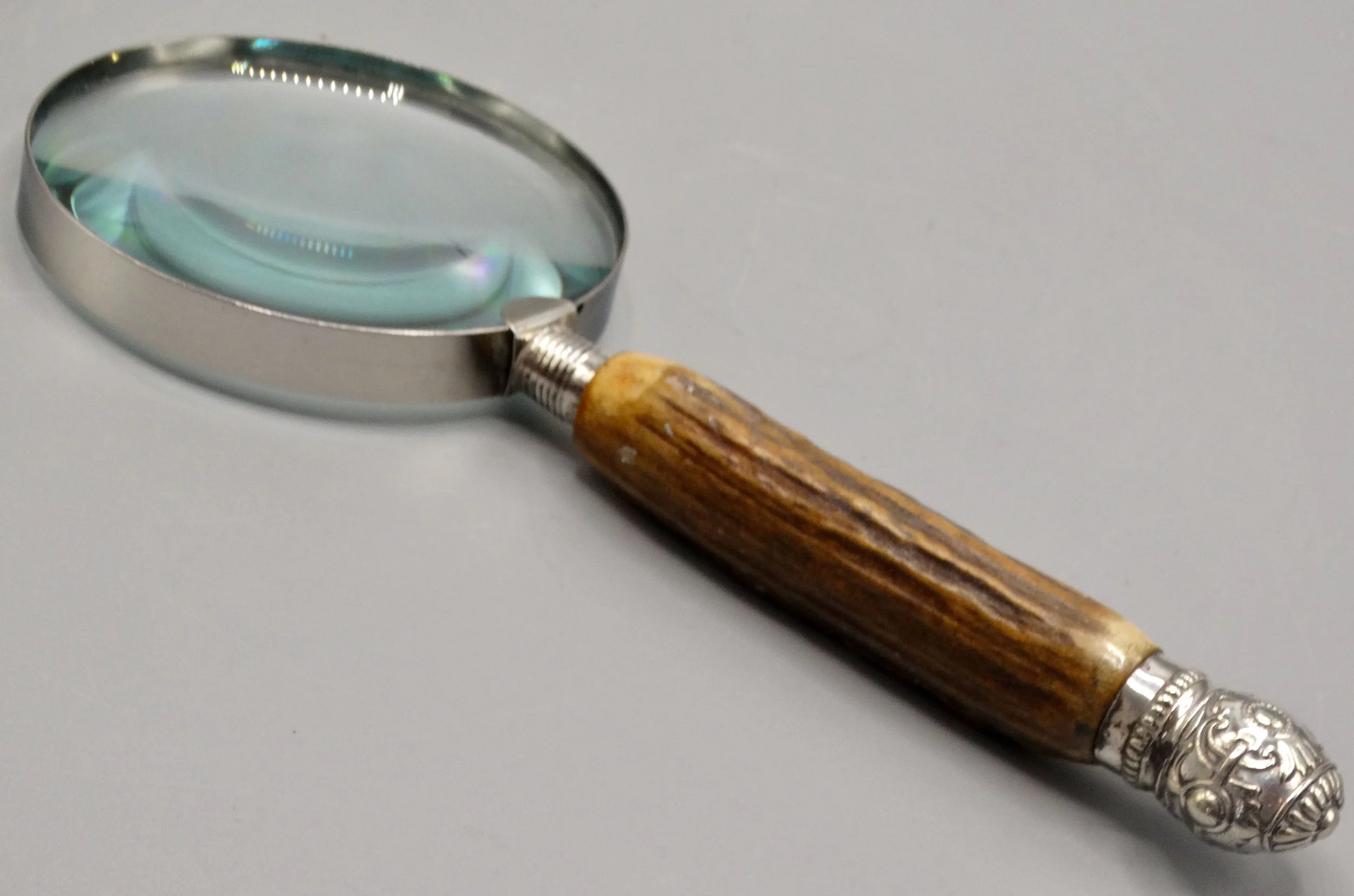 Antique English magnifying glass with natural stag horn handle and sterling silver mounts, hallmarked 1919