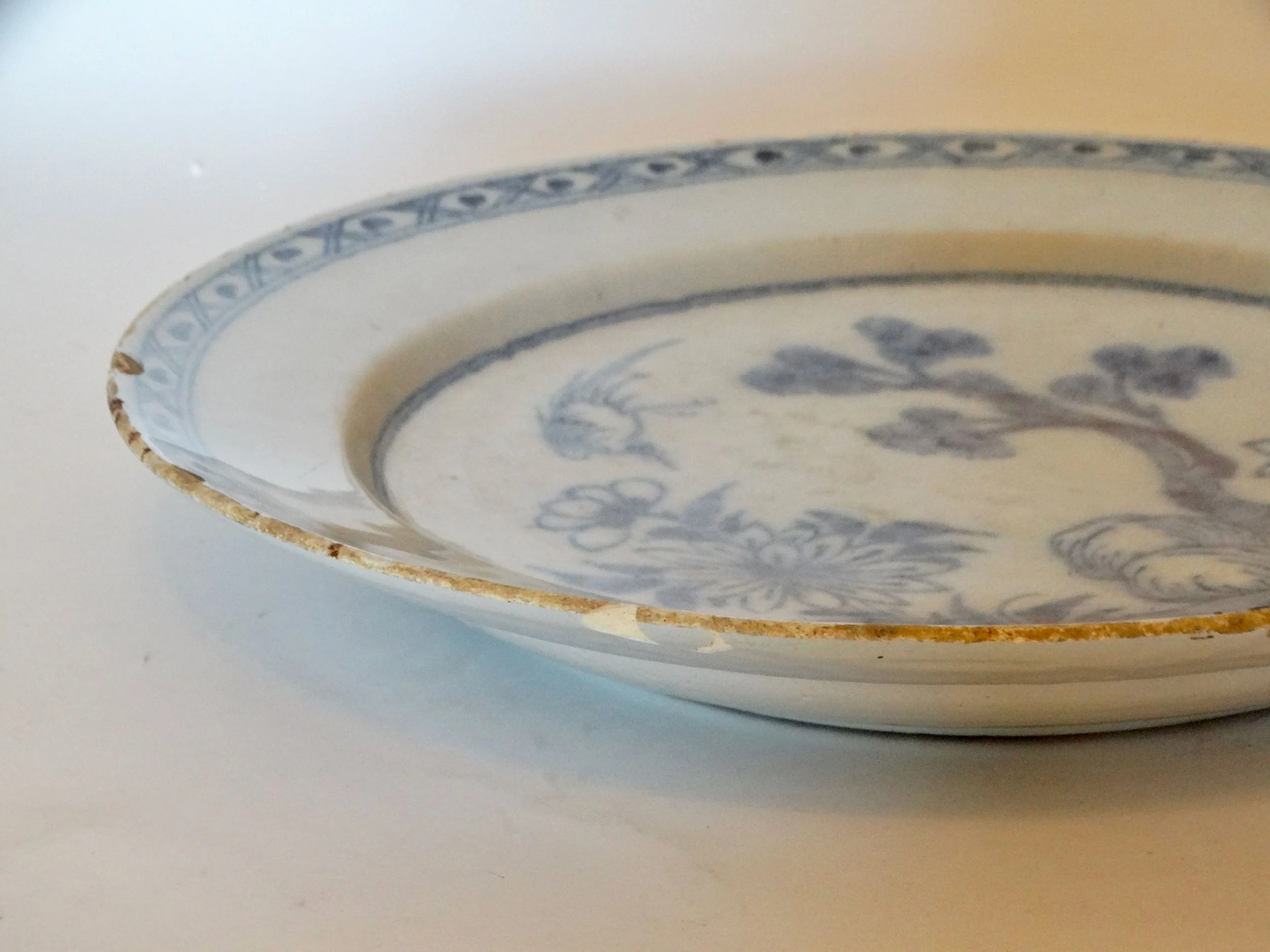 Rim detail of antique Delft blue and white chinoiserie charger.