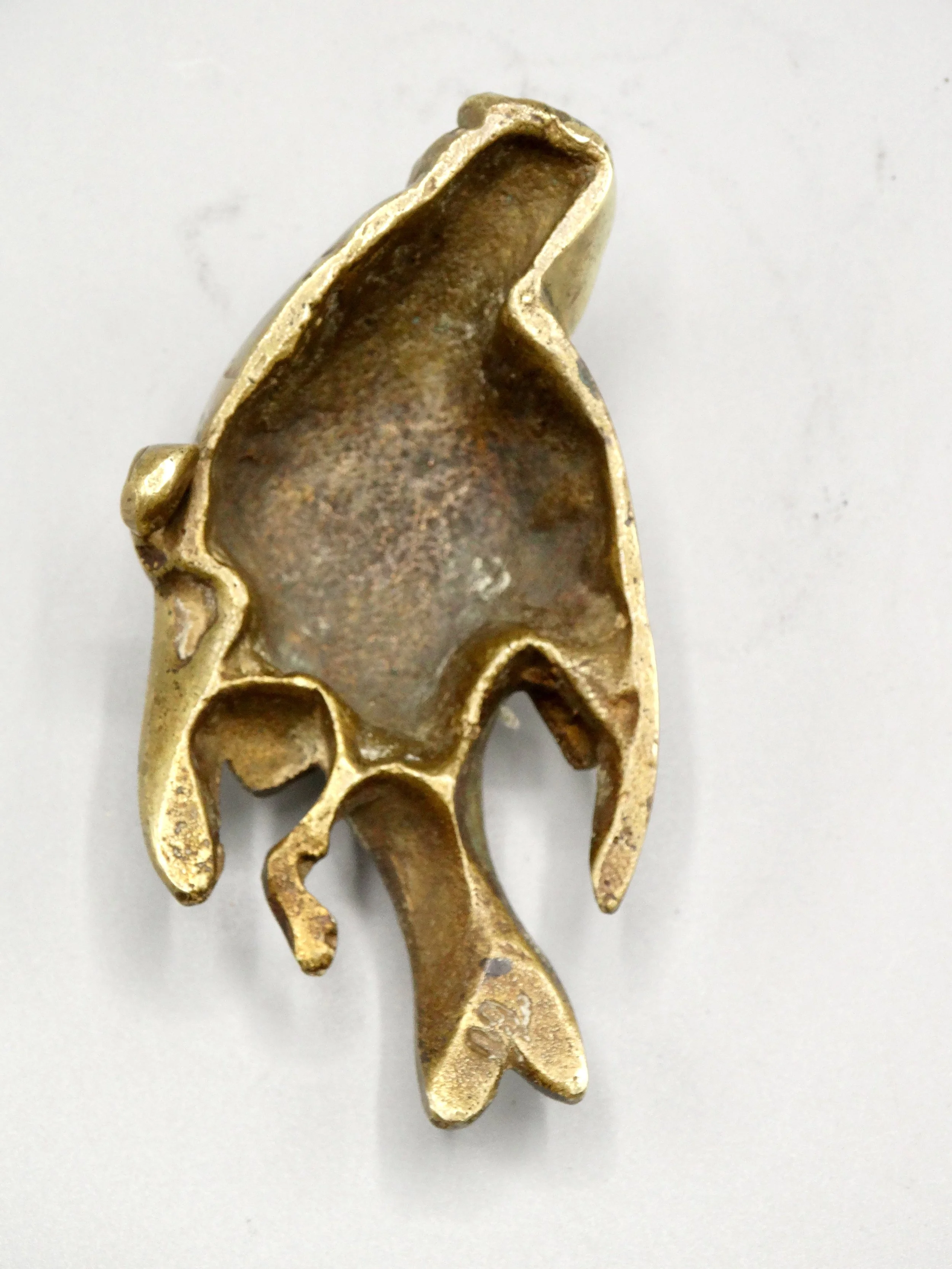 Underside of gilt bronze sparrow sculpture showing artist’s mark on tail attributed to Paul Comoléra.