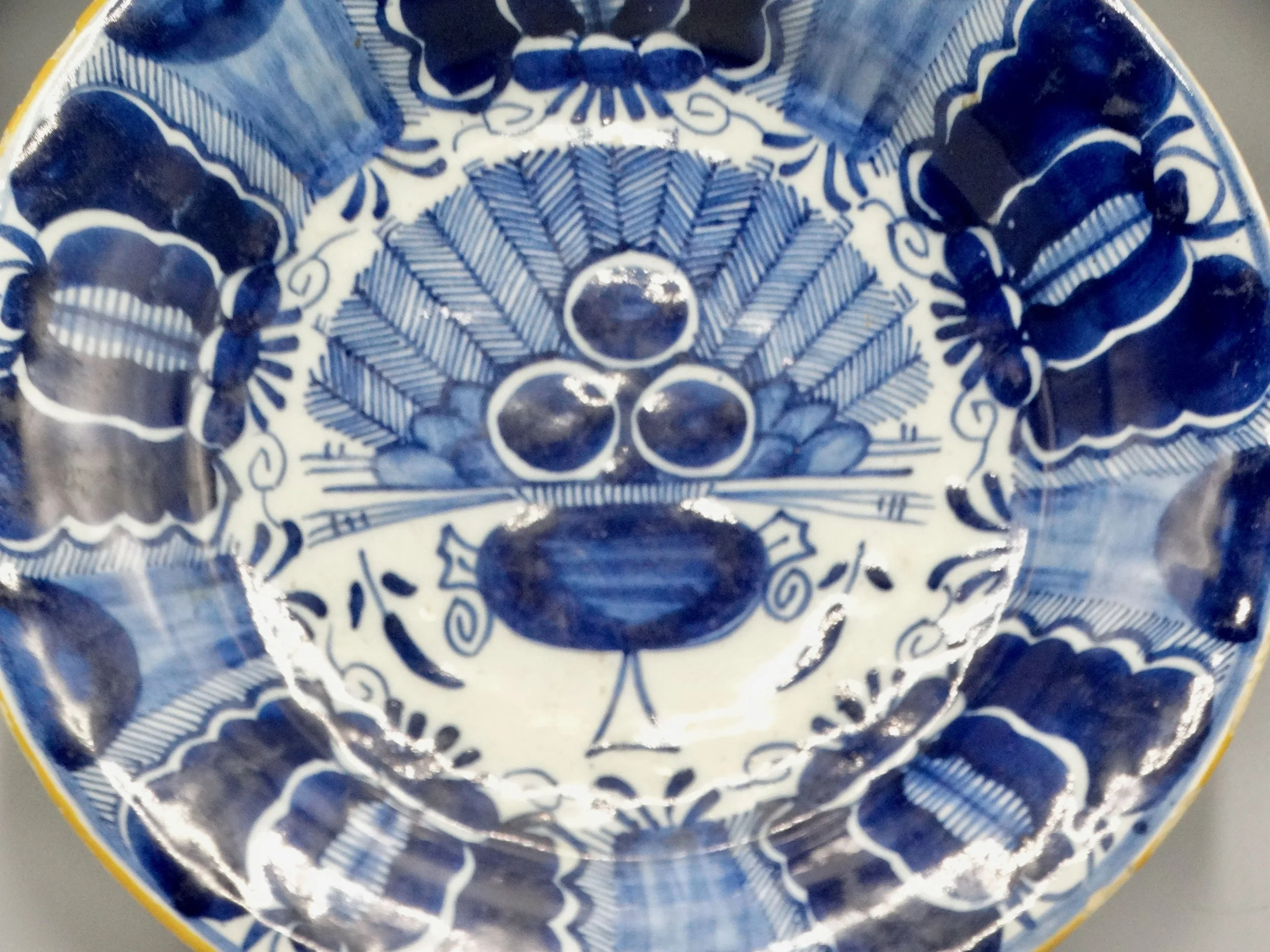 18th-century Dutch Delftware peacock plate, hand painted in blue and white, ochre rim, Three Bells maker mark