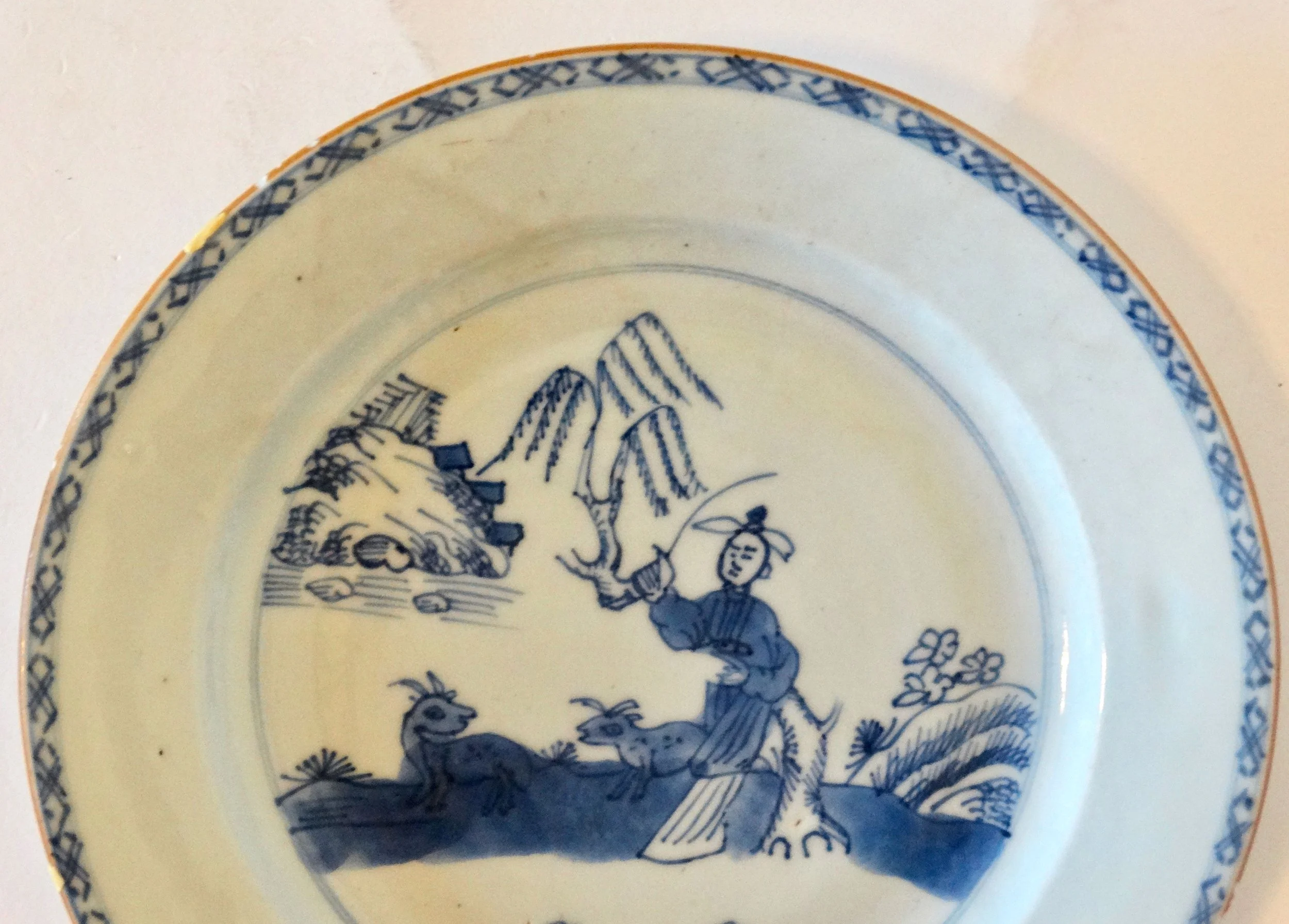 Floral and geometric border detail on 18th-century English Delftware chinoiserie plate, hand painted