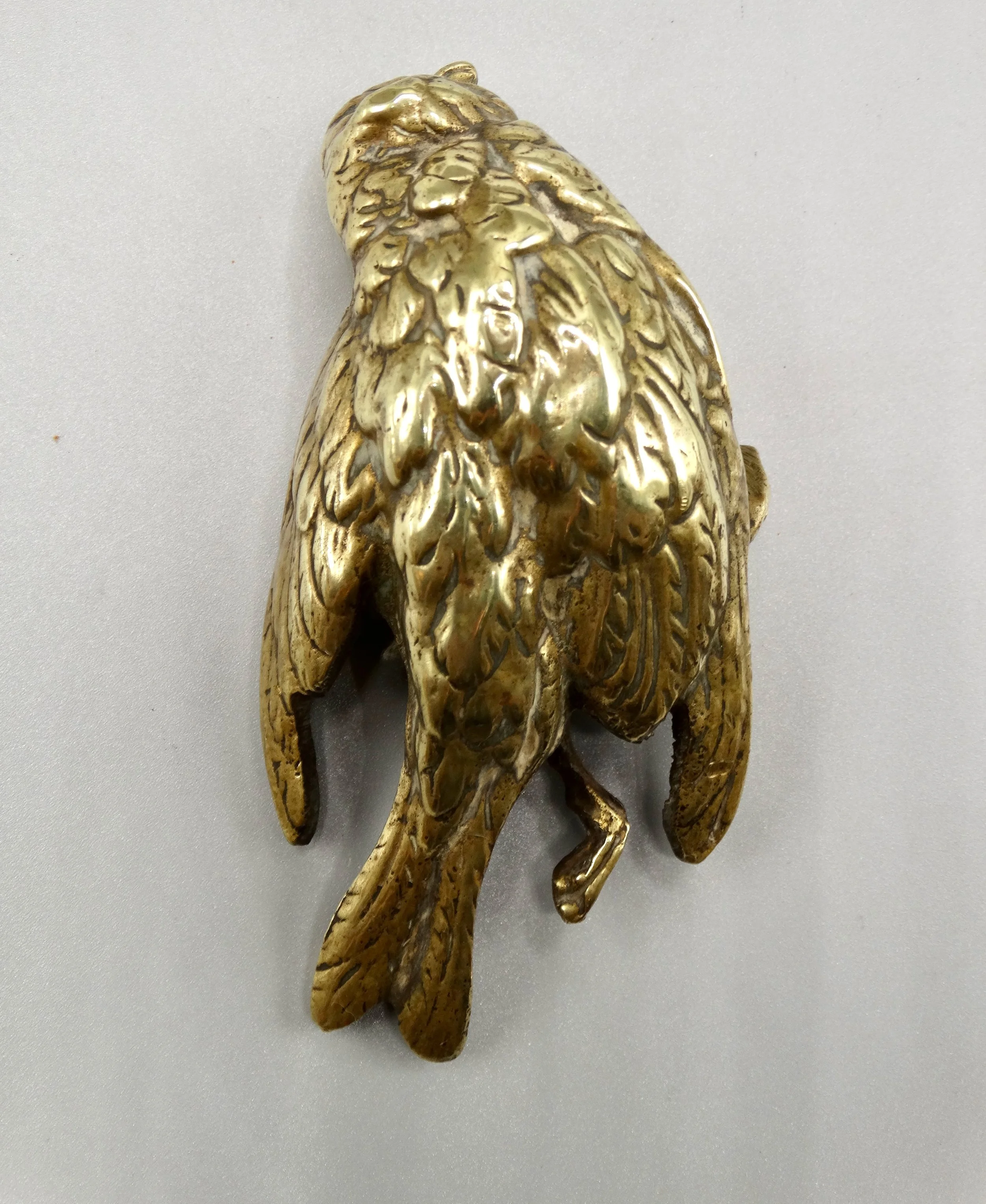 Rear view of gilt bronze Comoléra sparrow sculpture highlighting craftsmanship and patina.