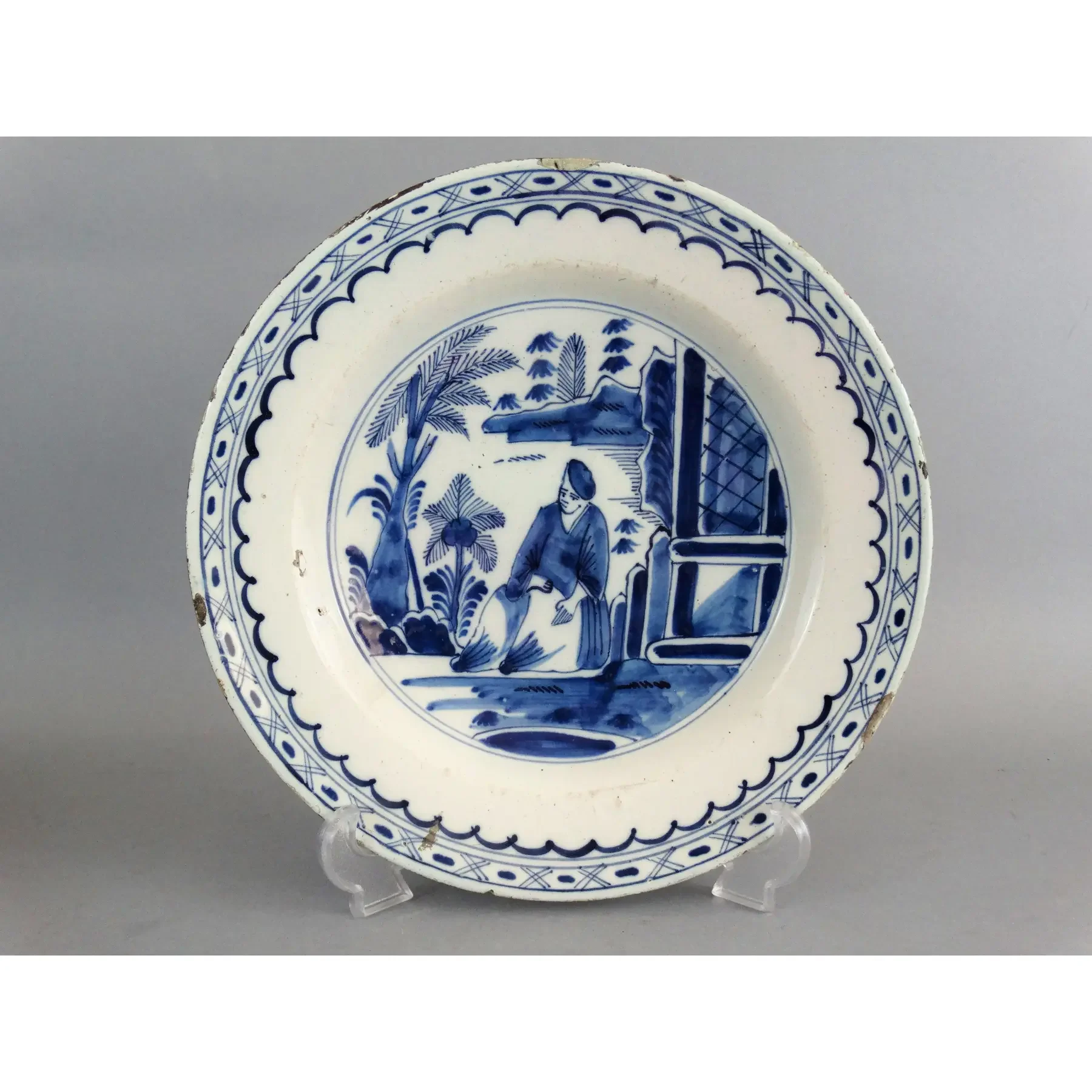 18th-century Dutch Delftware chinoiserie charger with figure in landscape, blue and white faience pottery