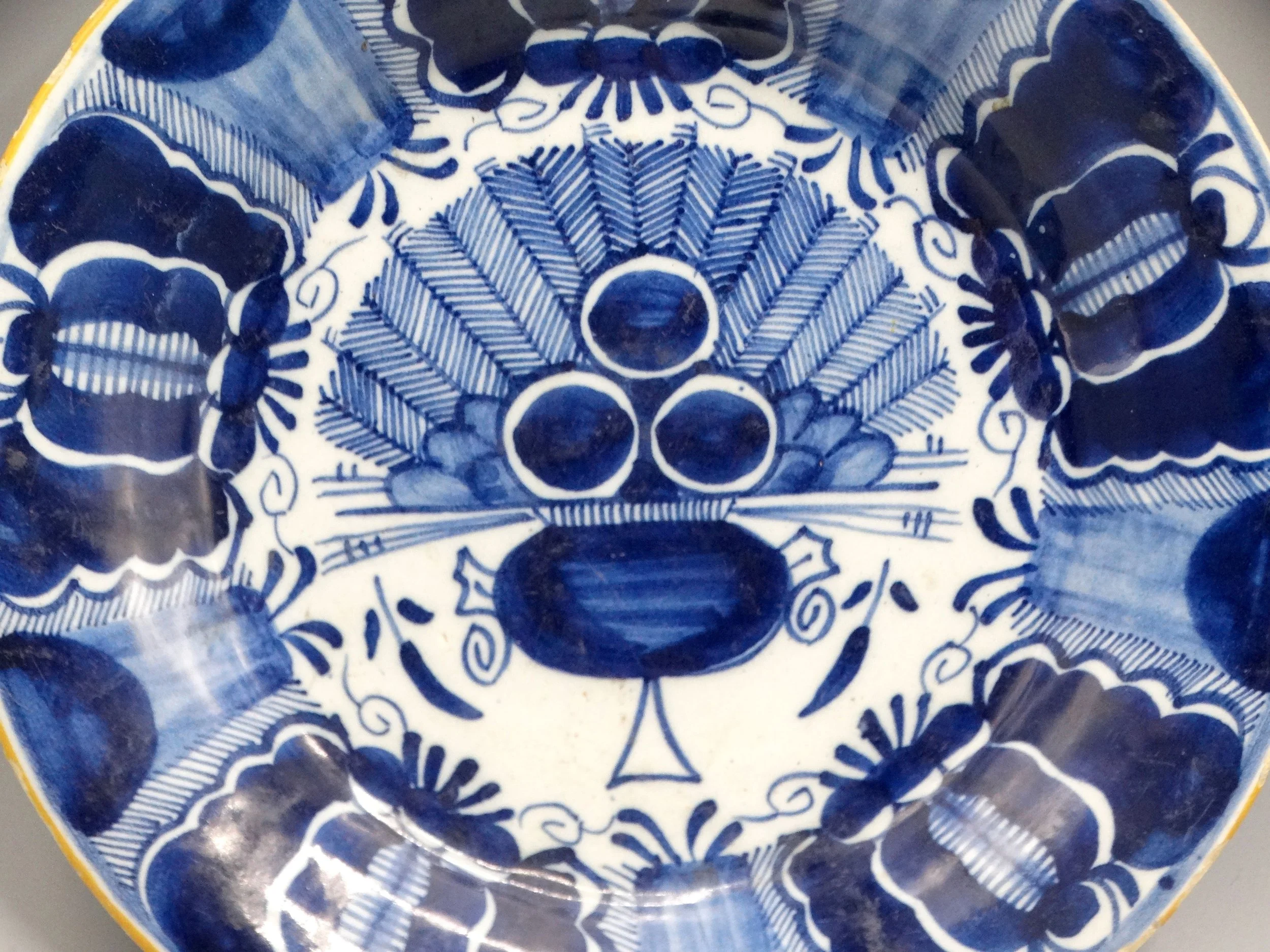 18th-century Dutch Delftware peacock plate, hand painted in blue and white, ochre rim, Three Bells maker mark