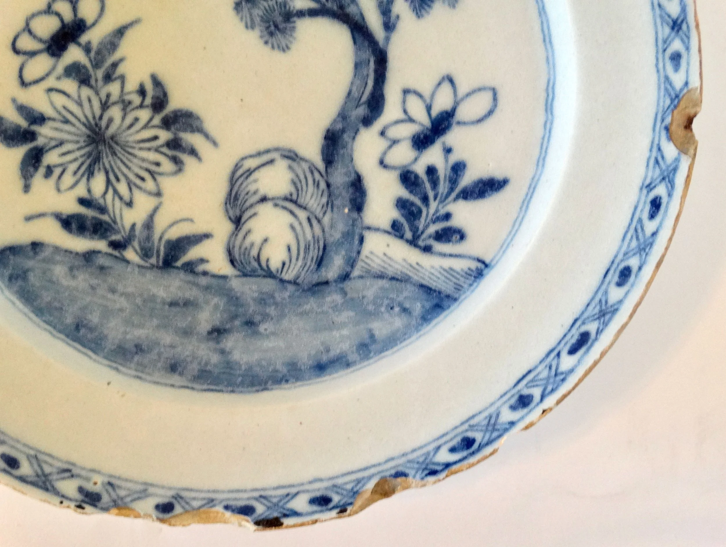 Rim detail of antique Delft blue and white chinoiserie charger.