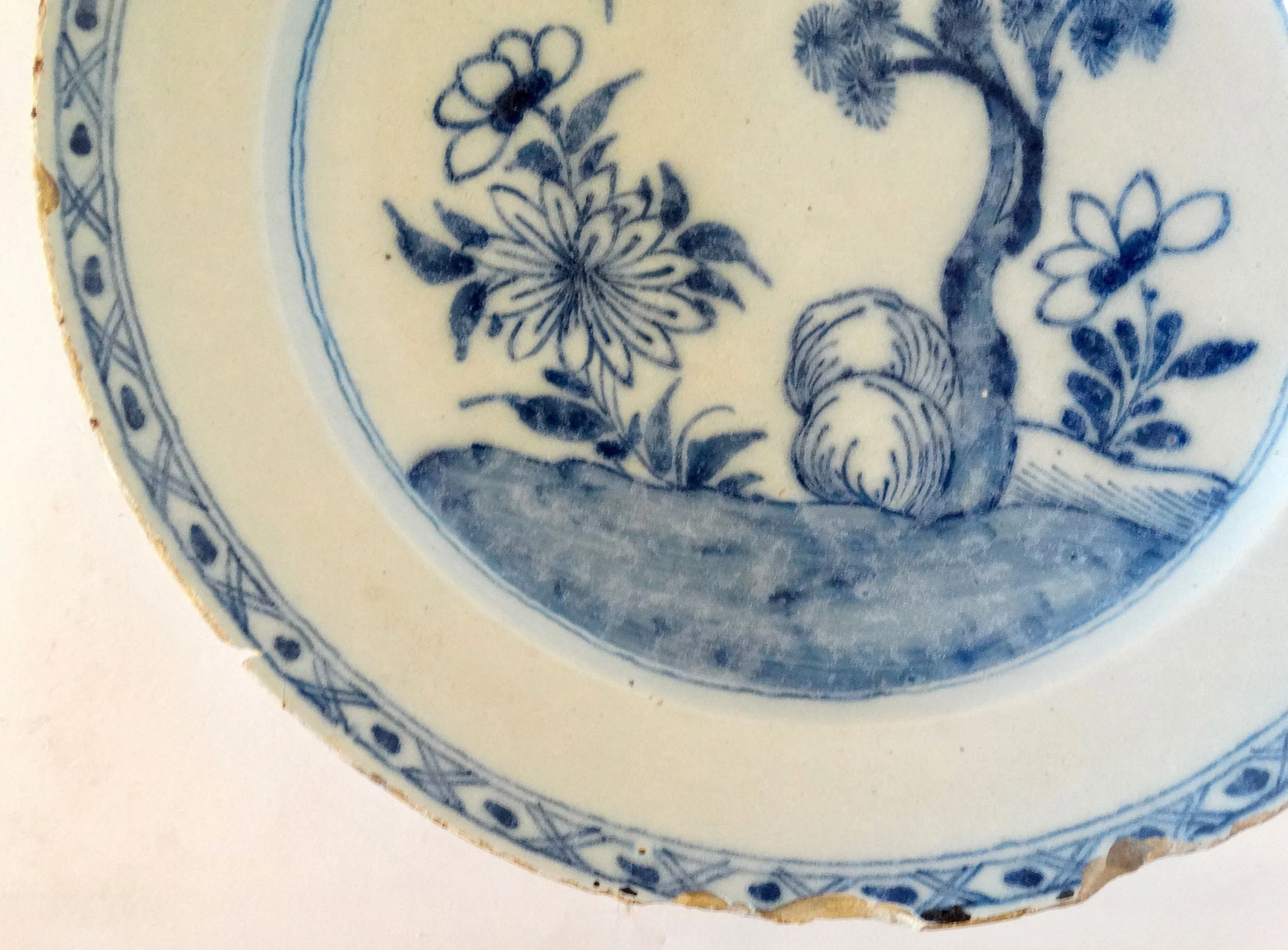 Rim detail of antique Delft blue and white chinoiserie charger.