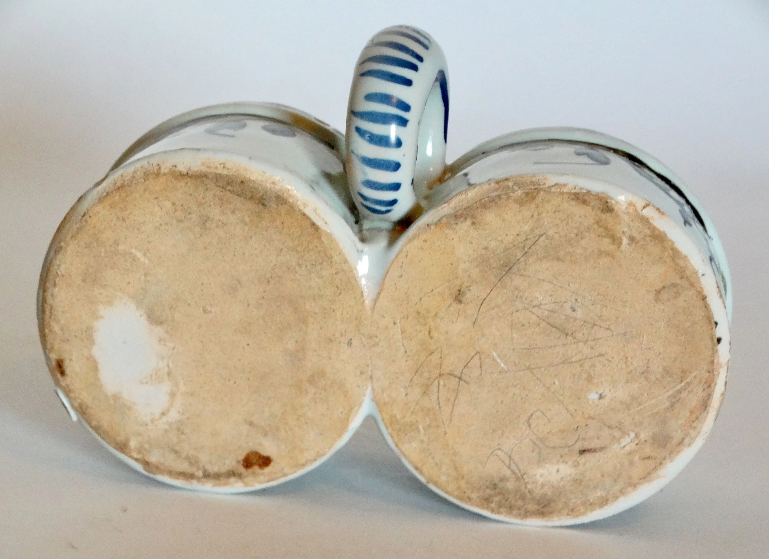 Bottom of 18th-century Delft faience presentier double dish, showing hand molded base and Delftware craftsmanship