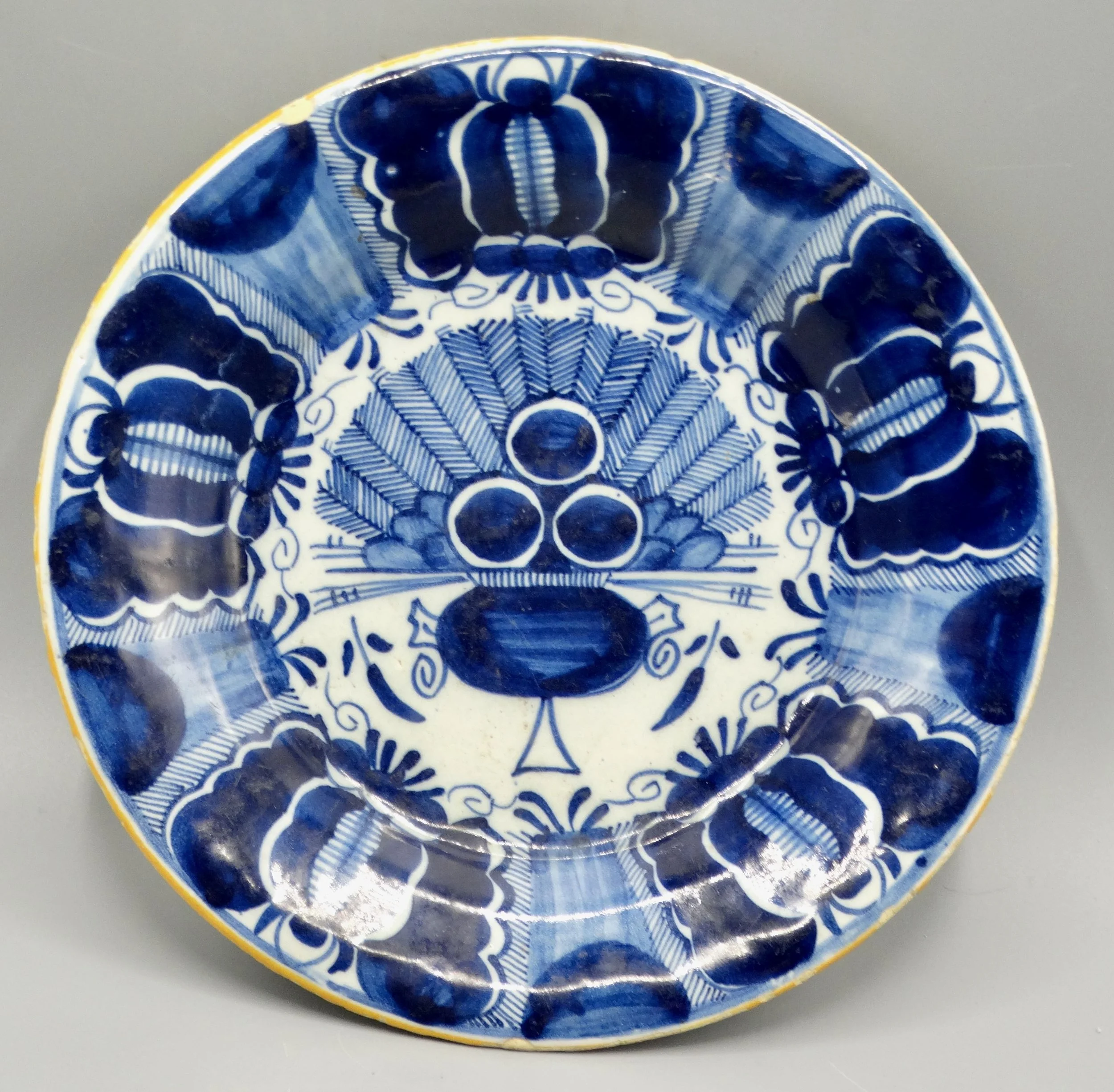 18th-century Dutch Delftware peacock plate, hand painted in blue and white, ochre rim, Three Bells maker mark