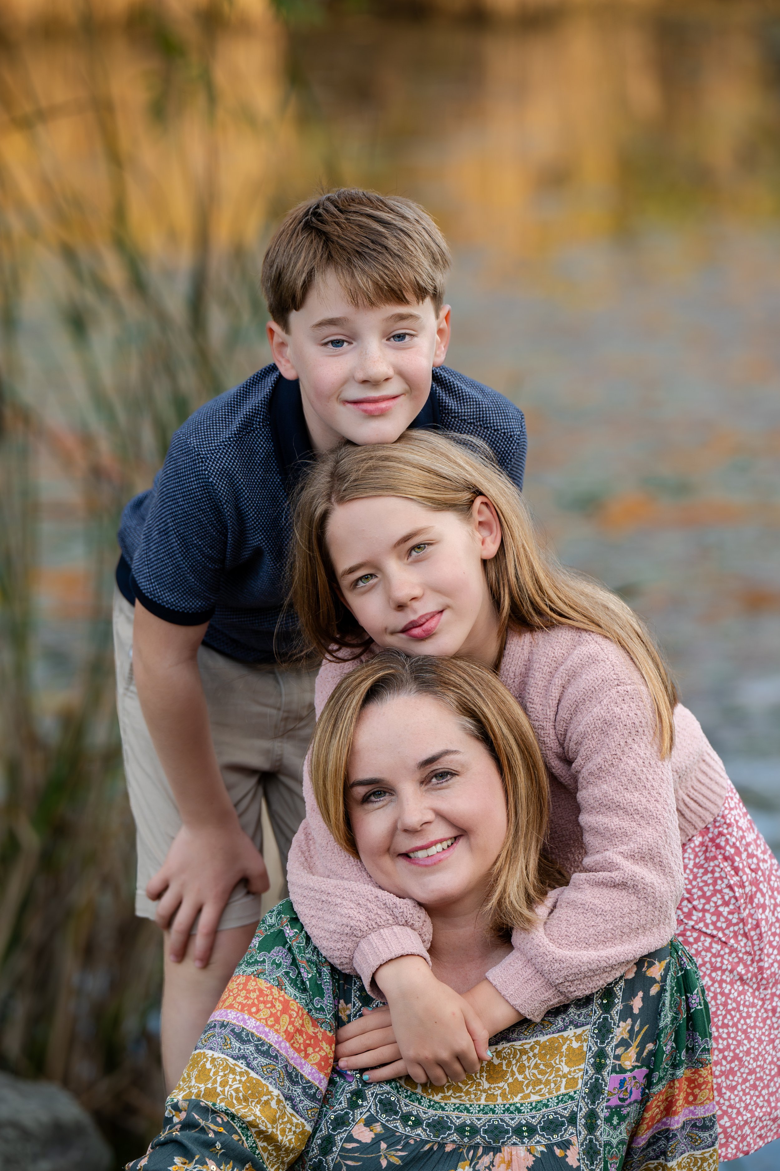 Smiling woman with two children in an outdoor setting