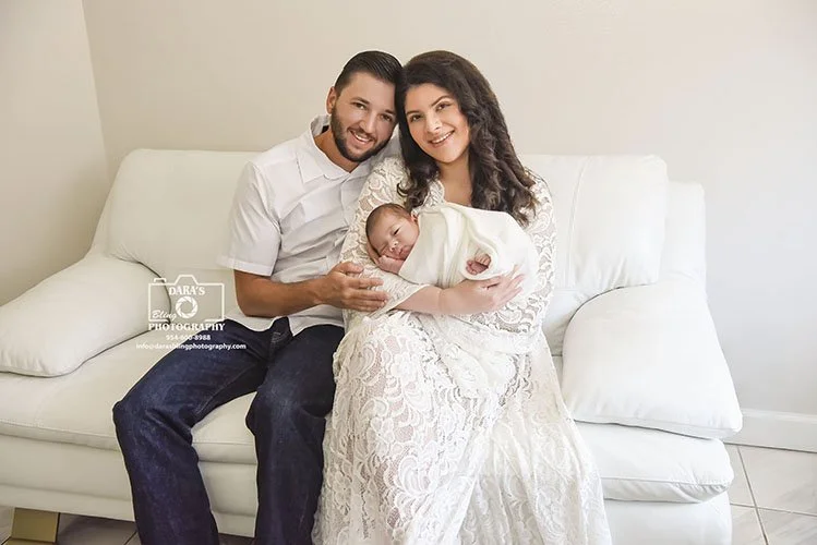 newborn-family-lifestyle-session parents sitting on couch at home with newborn baby
