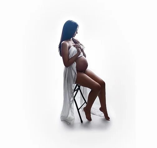 maternity photography studio Pembroke Pines, fl woman draped with fabric pregnancy sitting on stool