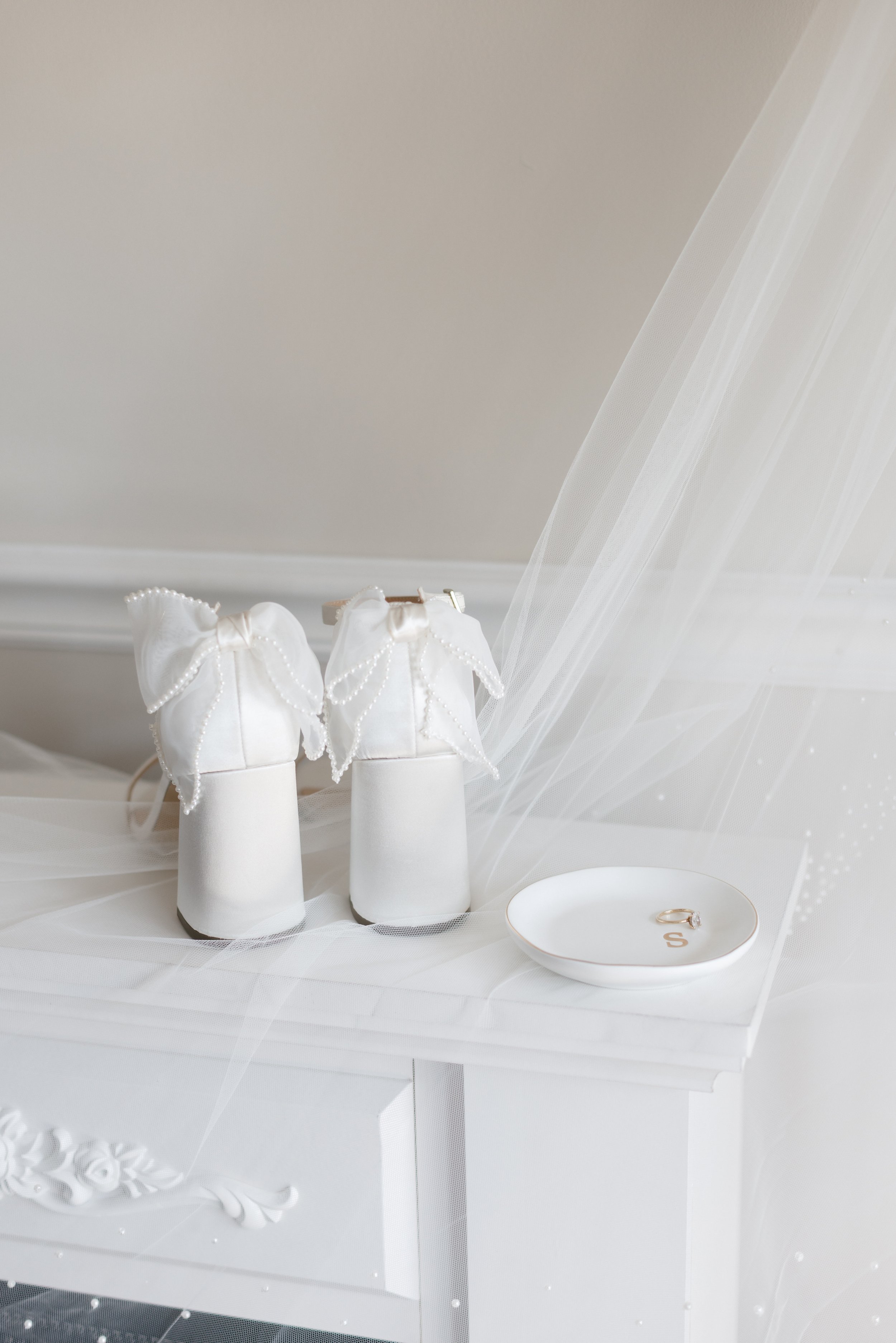 Flat lay of veil and perfume bottles, detail captured in documentary style wedding photography