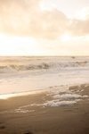 Ocean waves at golden hour, a serene backdrop for candid wedding photography near Miami