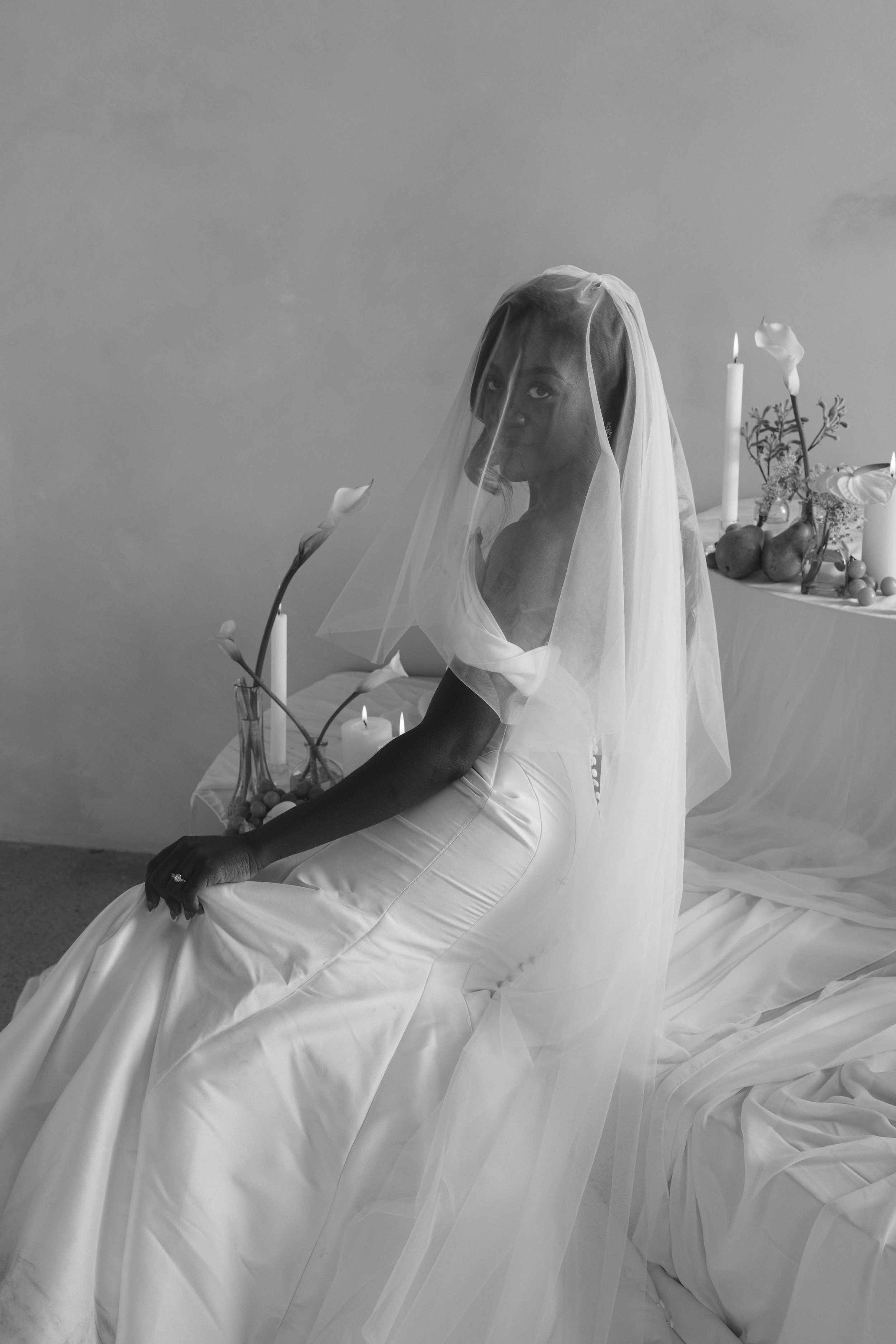 Bride sitting in veil near candles, documentary style wedding photography
