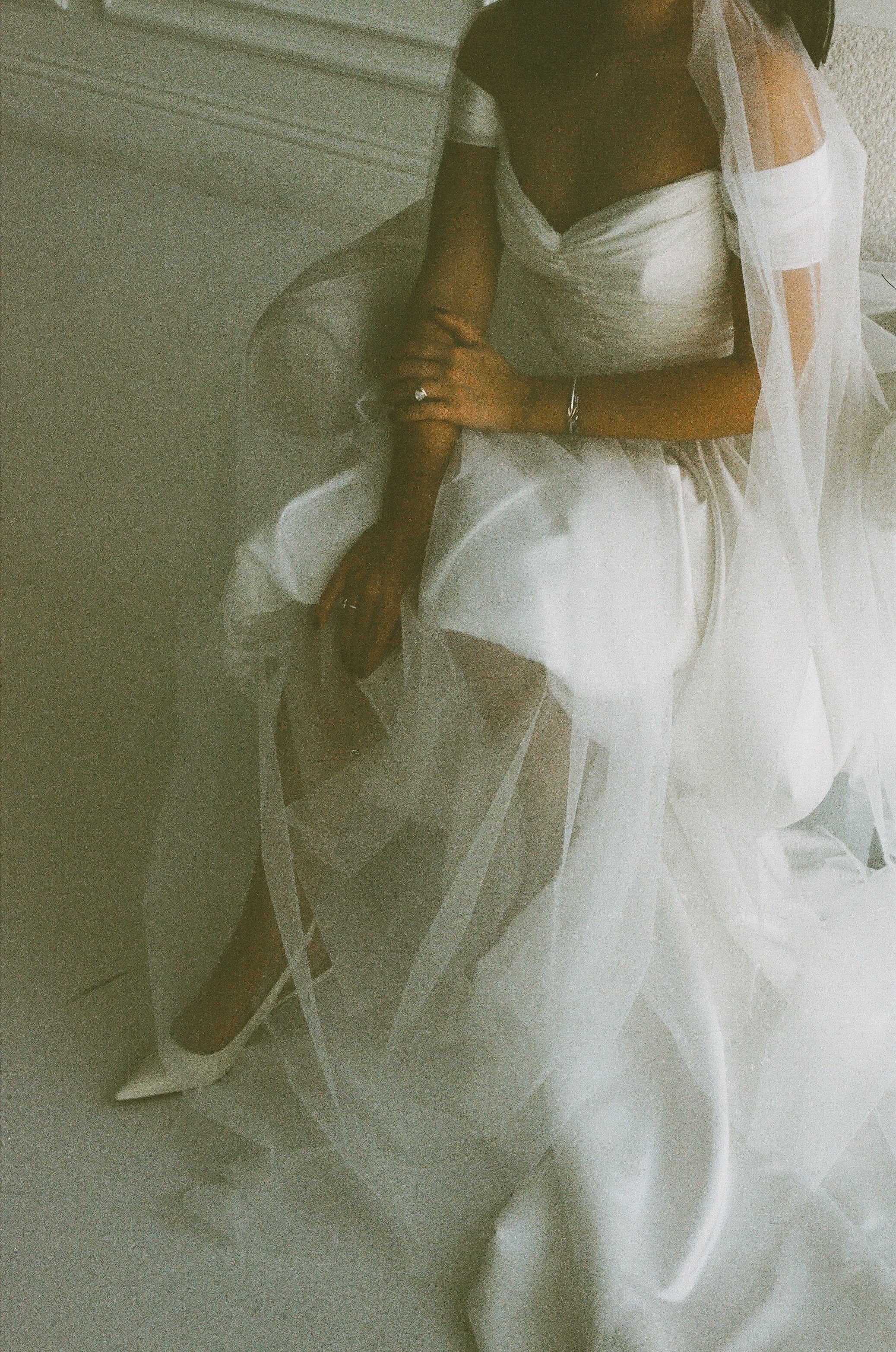 Bride’s dress and veil in motion blur, artistic detail by documentary wedding photographer