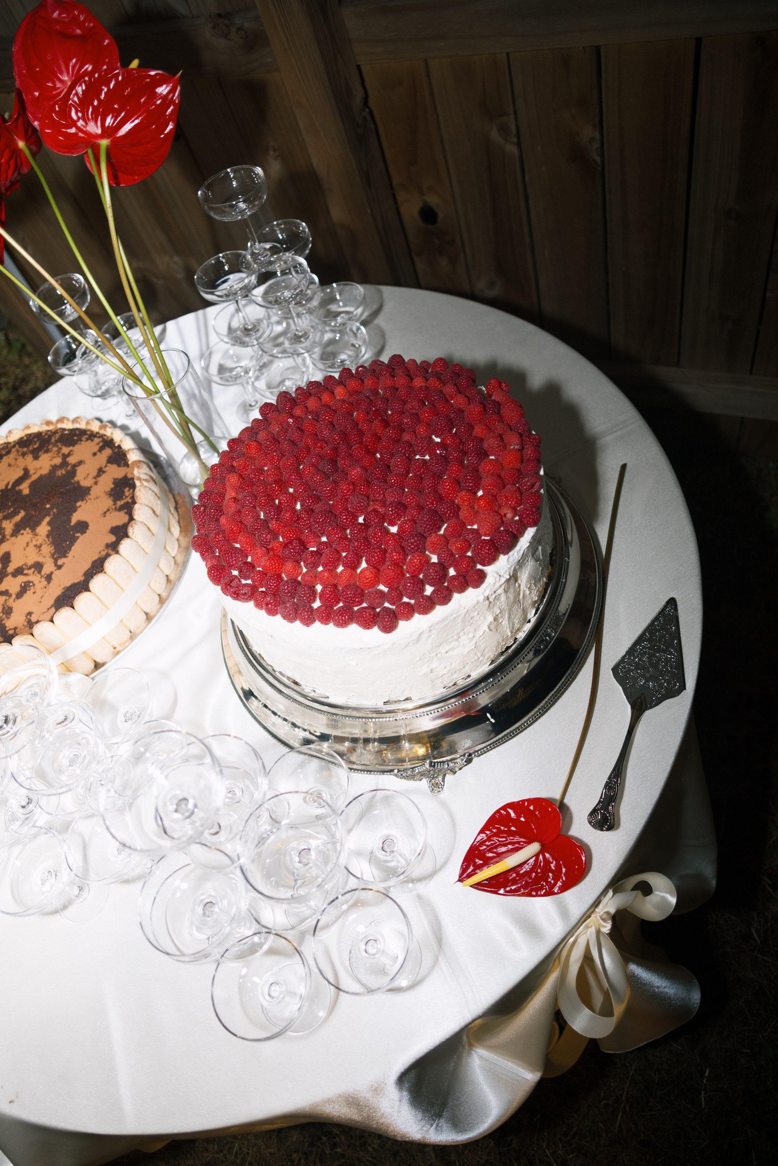 Red velvet cake with champagne glasses, wedding detail in documentary style wedding photography