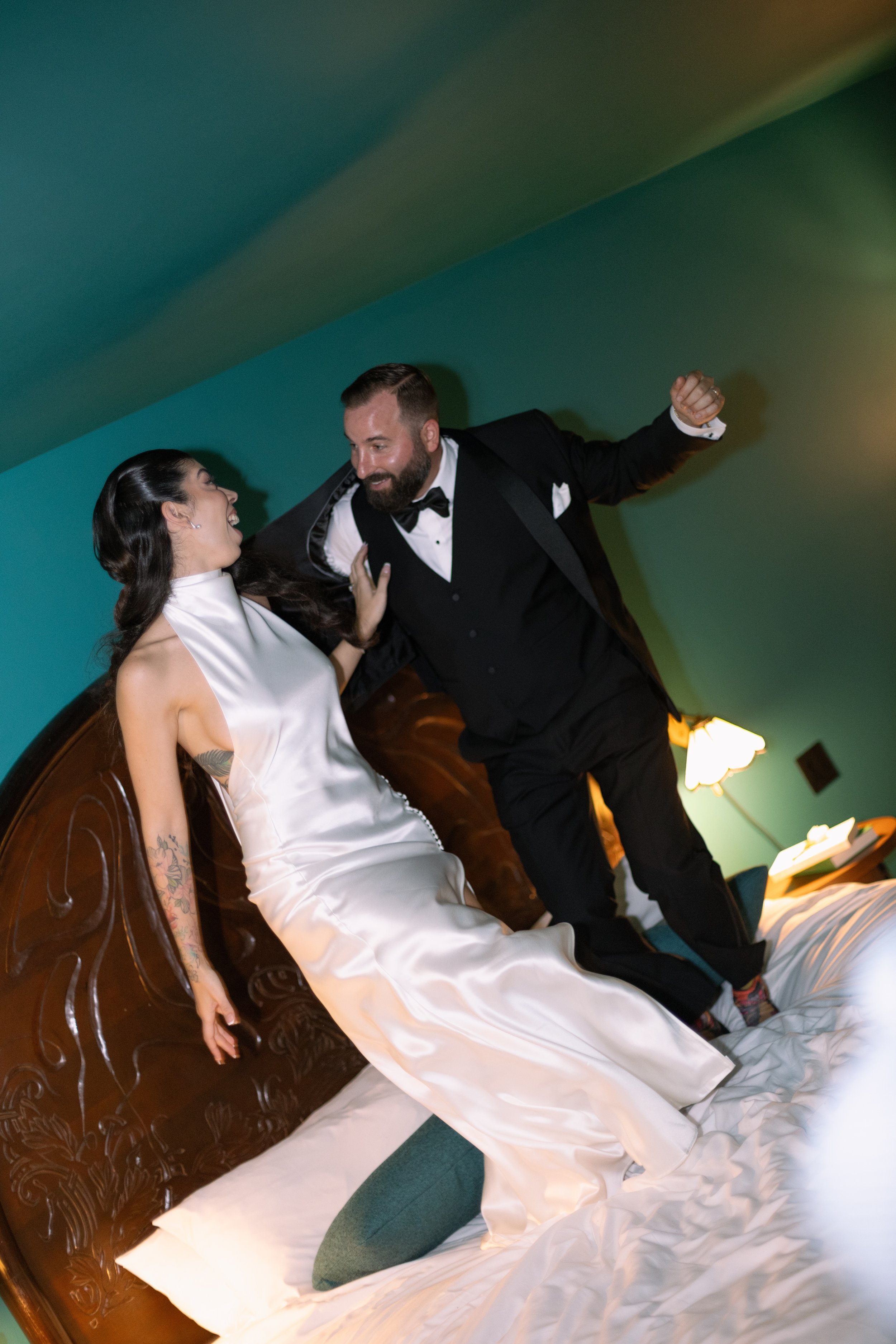 Bride and groom dancing dramatically indoors, reception energy by documentary wedding photographer