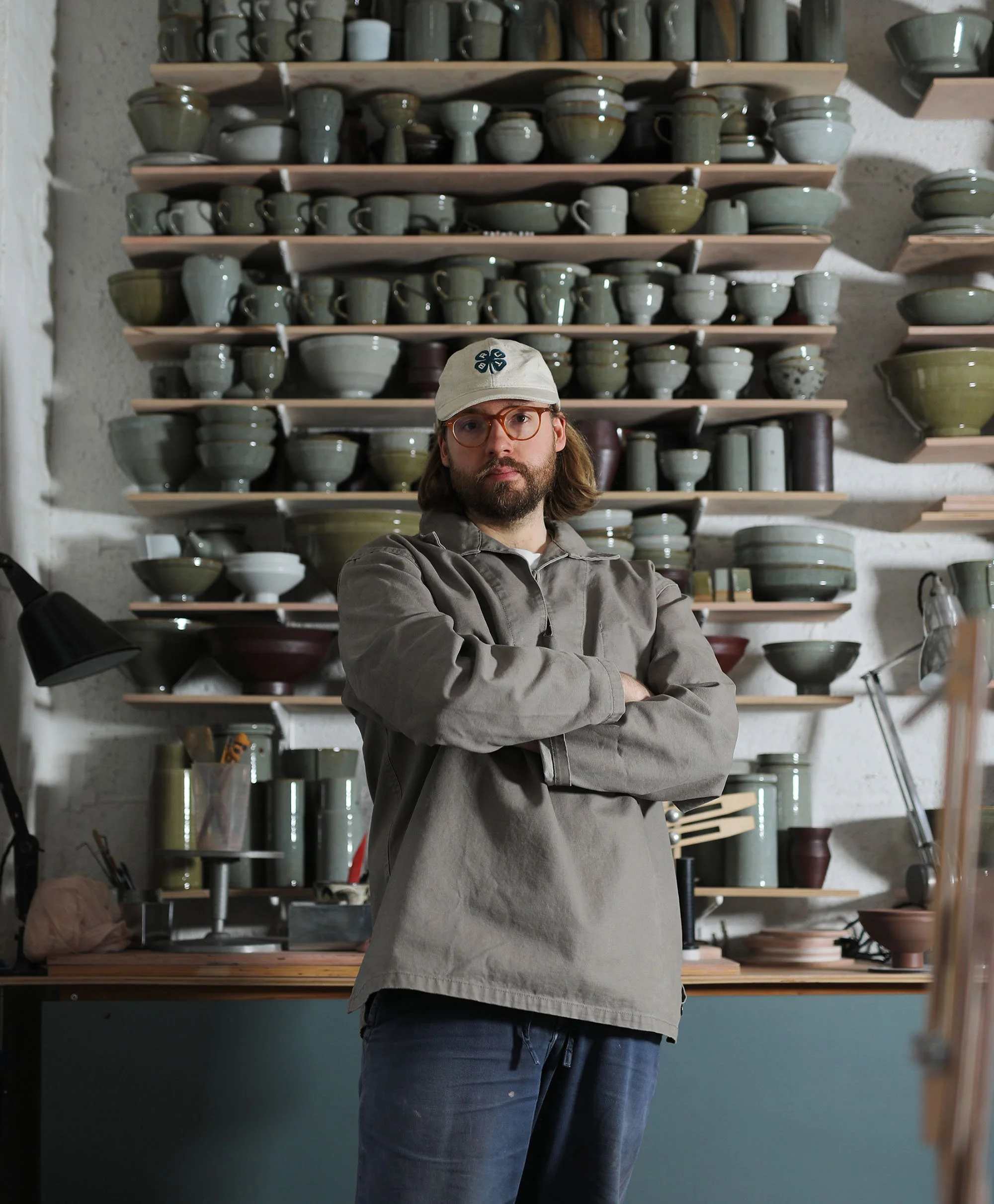 Florian Gadsby stood in front of shelves of ceramics