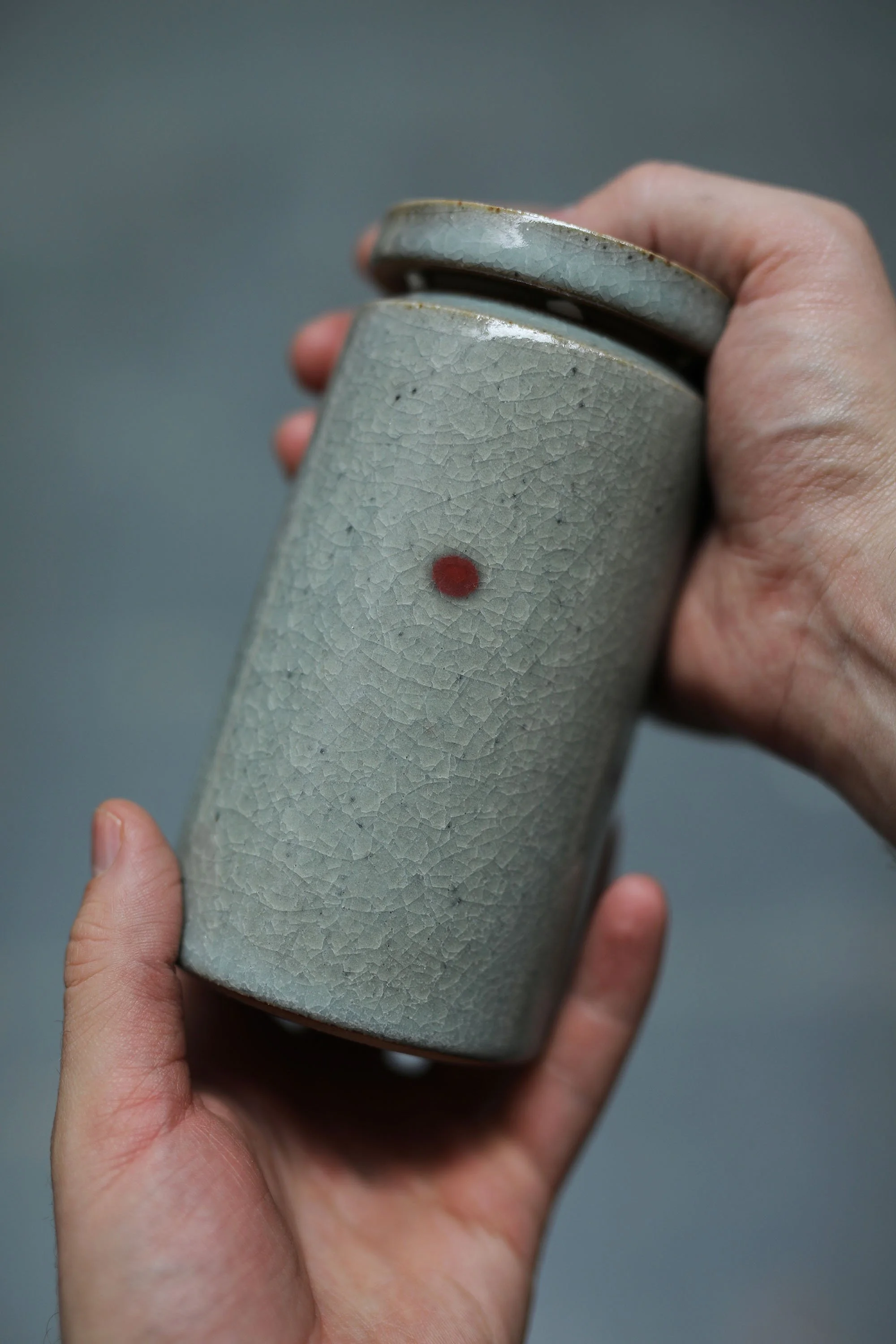 Hands holding a ceramic vessel