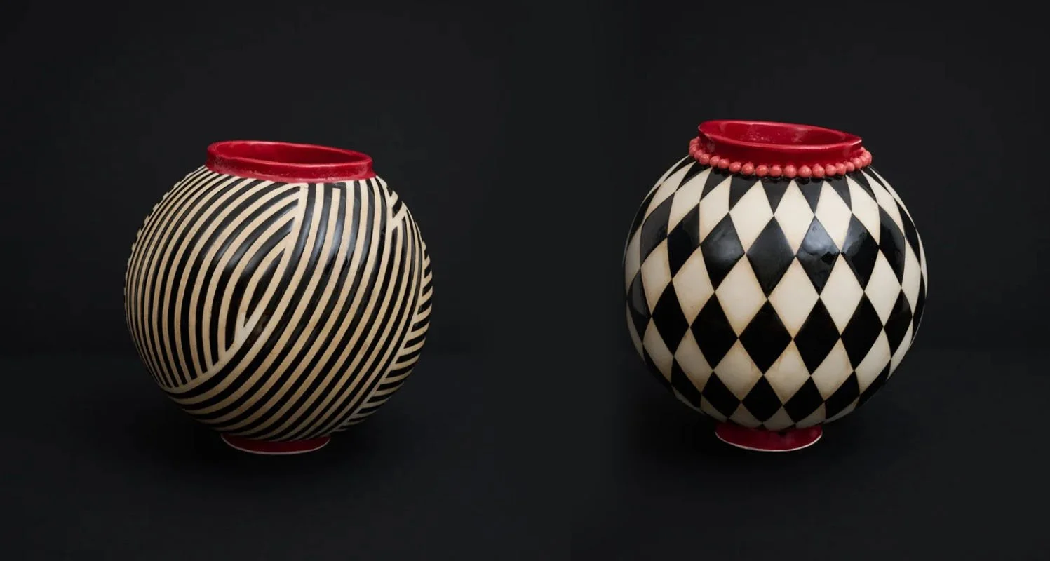 2 black, white and red ceramic vessels