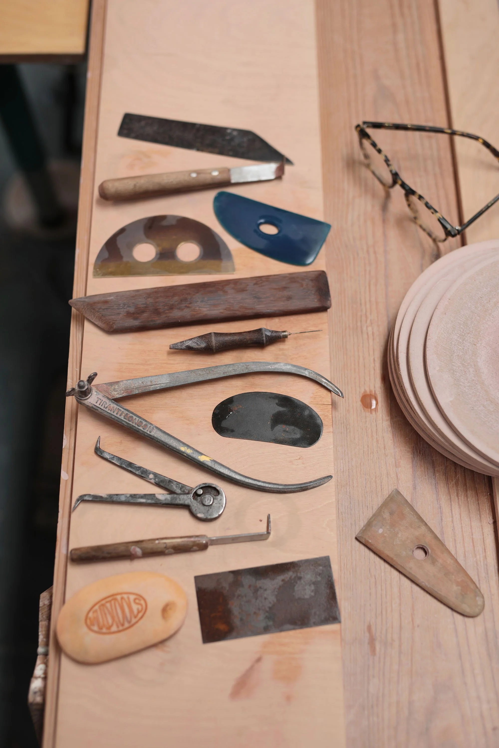 A selection of potter's tools on a bench