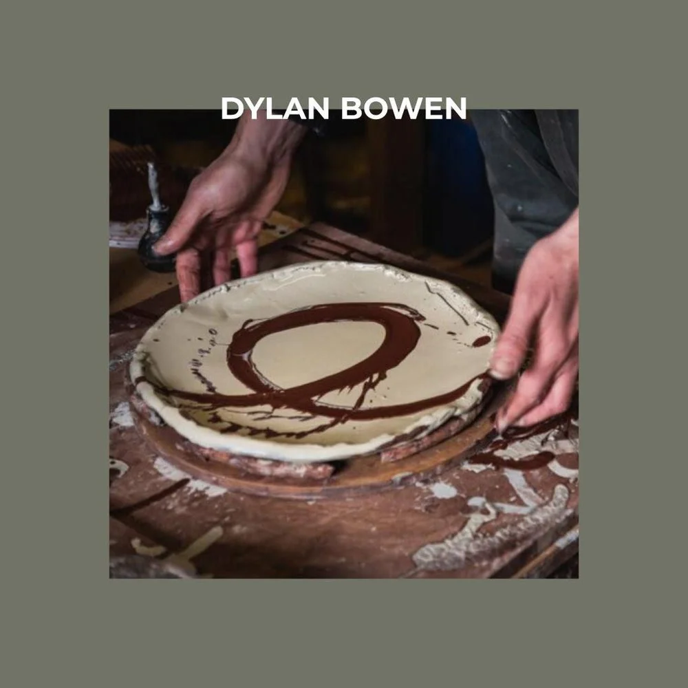 Hands holding ceramic decorated plate