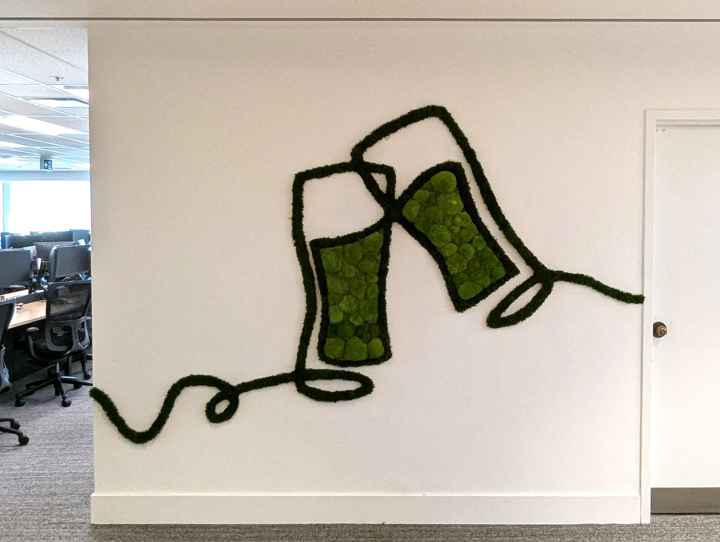 A custom moss feature translating brand messaging into a dimensional, tactile experience.