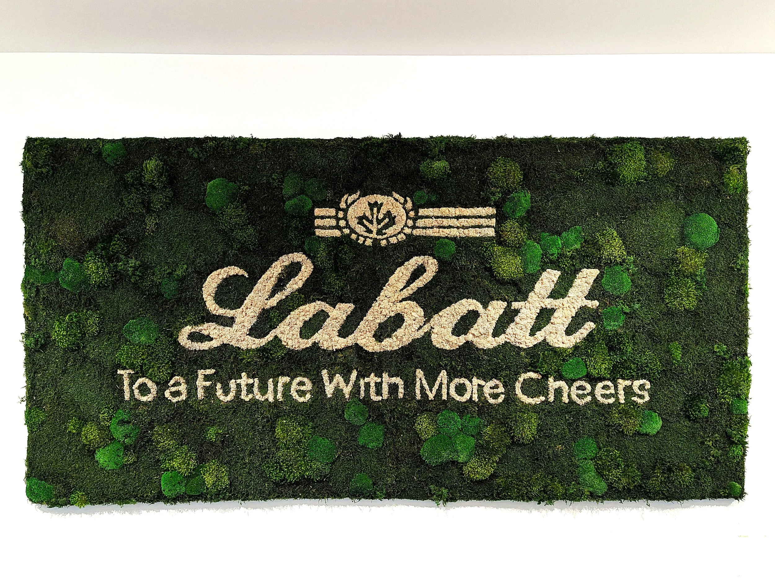 A branded biophilic installation integrating identity with natural material expression.