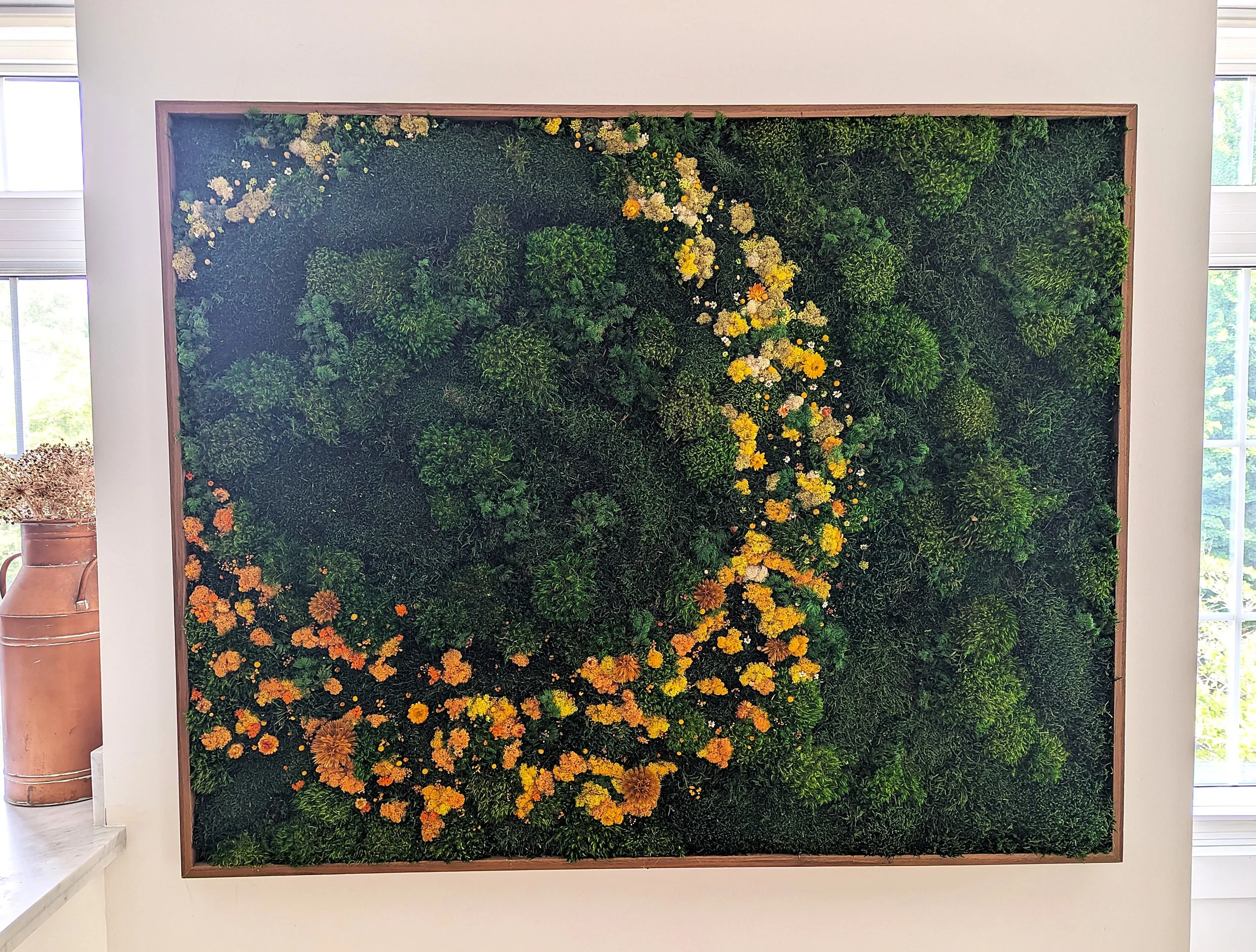 A bespoke installation combining preserved florals and moss to create a soft, immersive focal point.