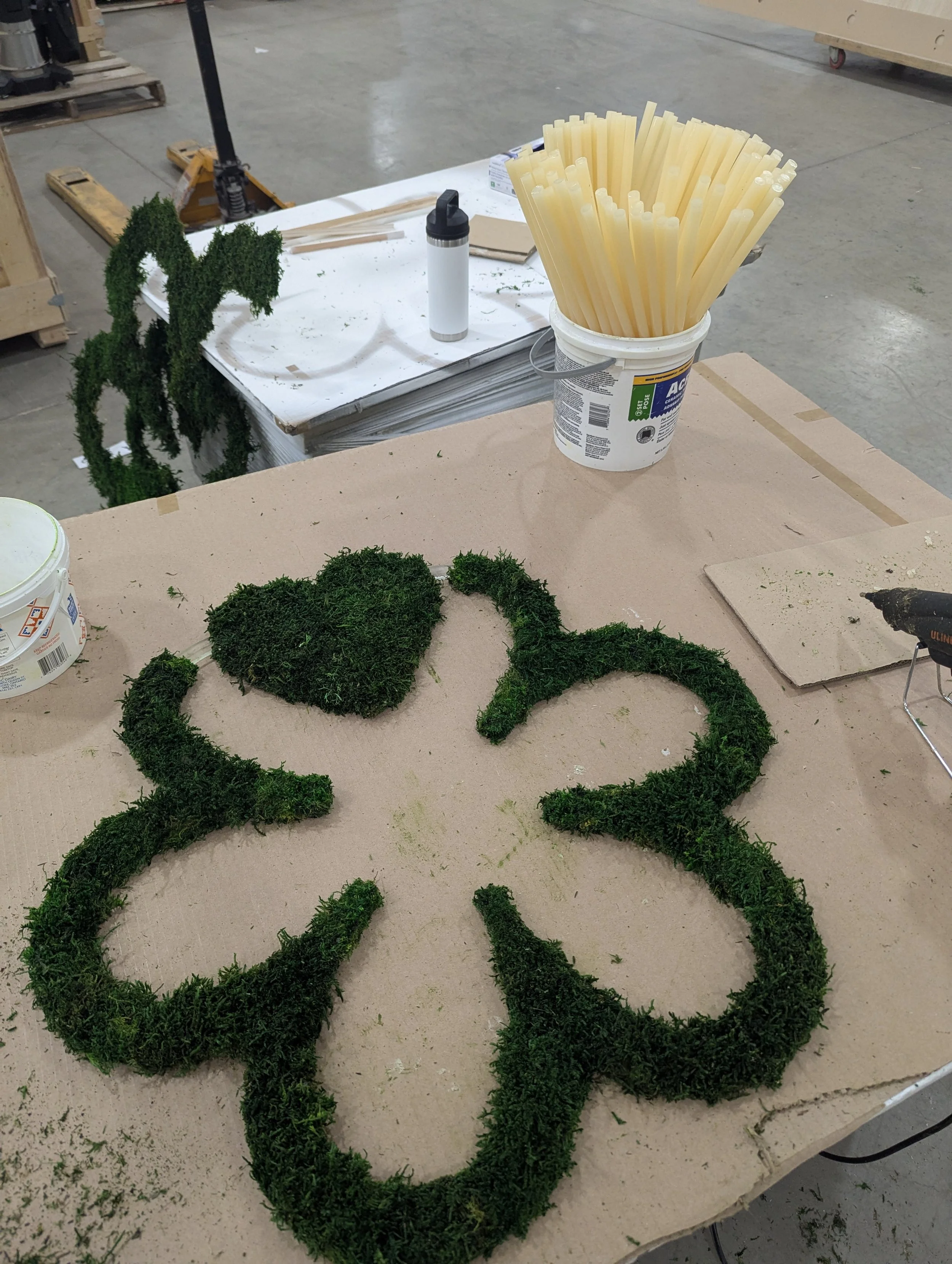 A custom-designed feature integrating brand identity with sculptural botanical materials.