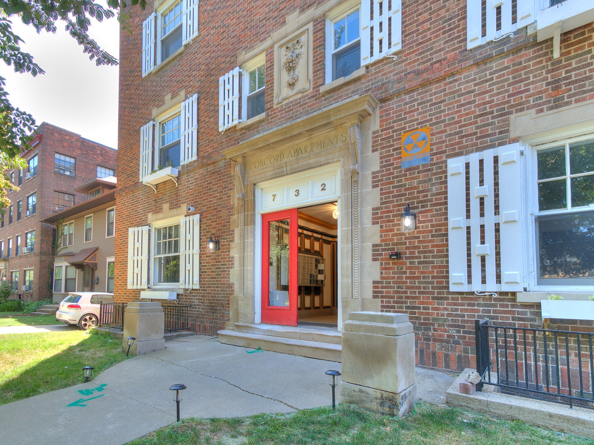 Historic brick exterior of The Concord Apartments in Des Moines, Iowa, a multi-family property managed by DEV Partners, showcasing traditional architecture ideal for passive income rentals and real estate investments.