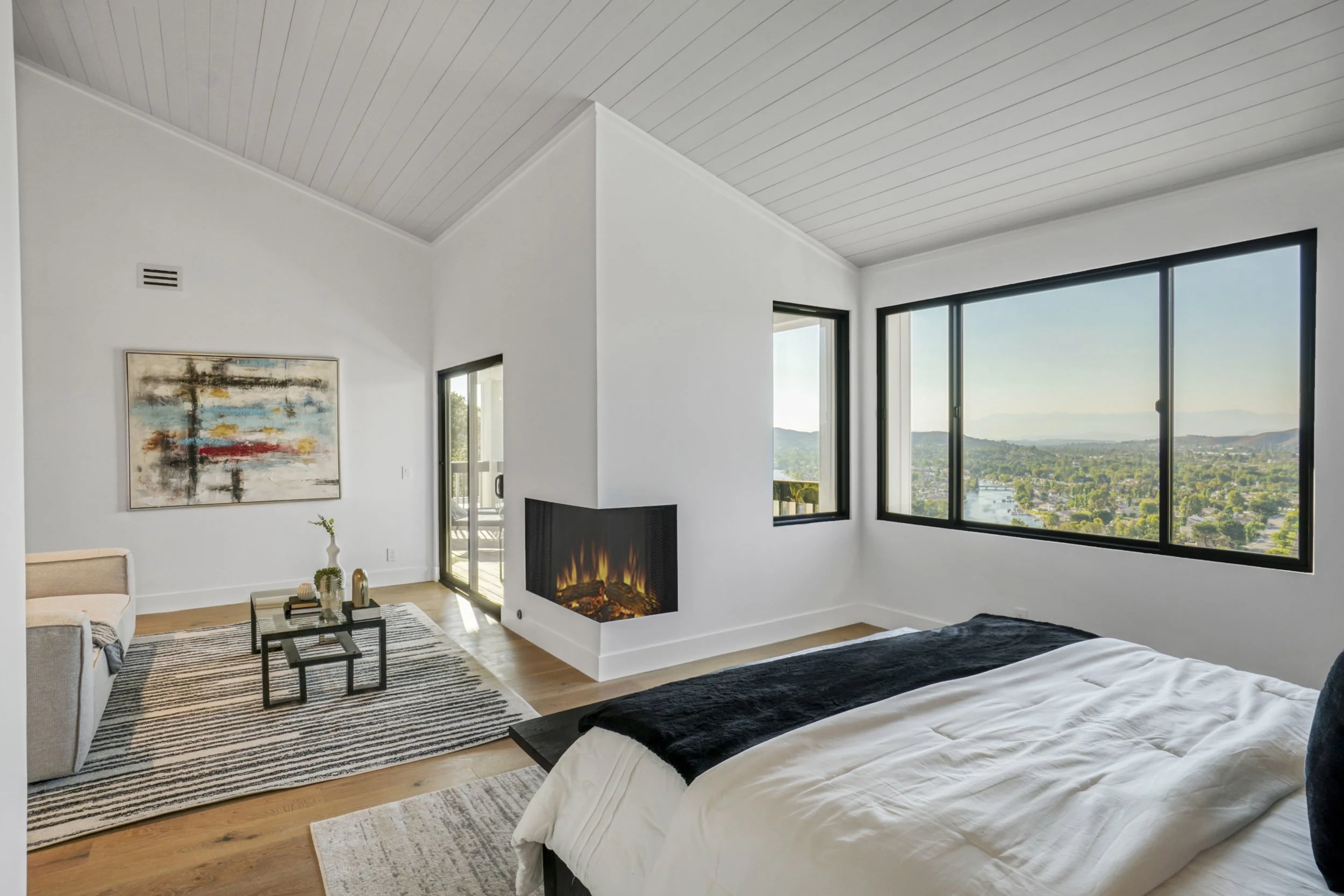 Bedroom with a fireplace and hillside view
