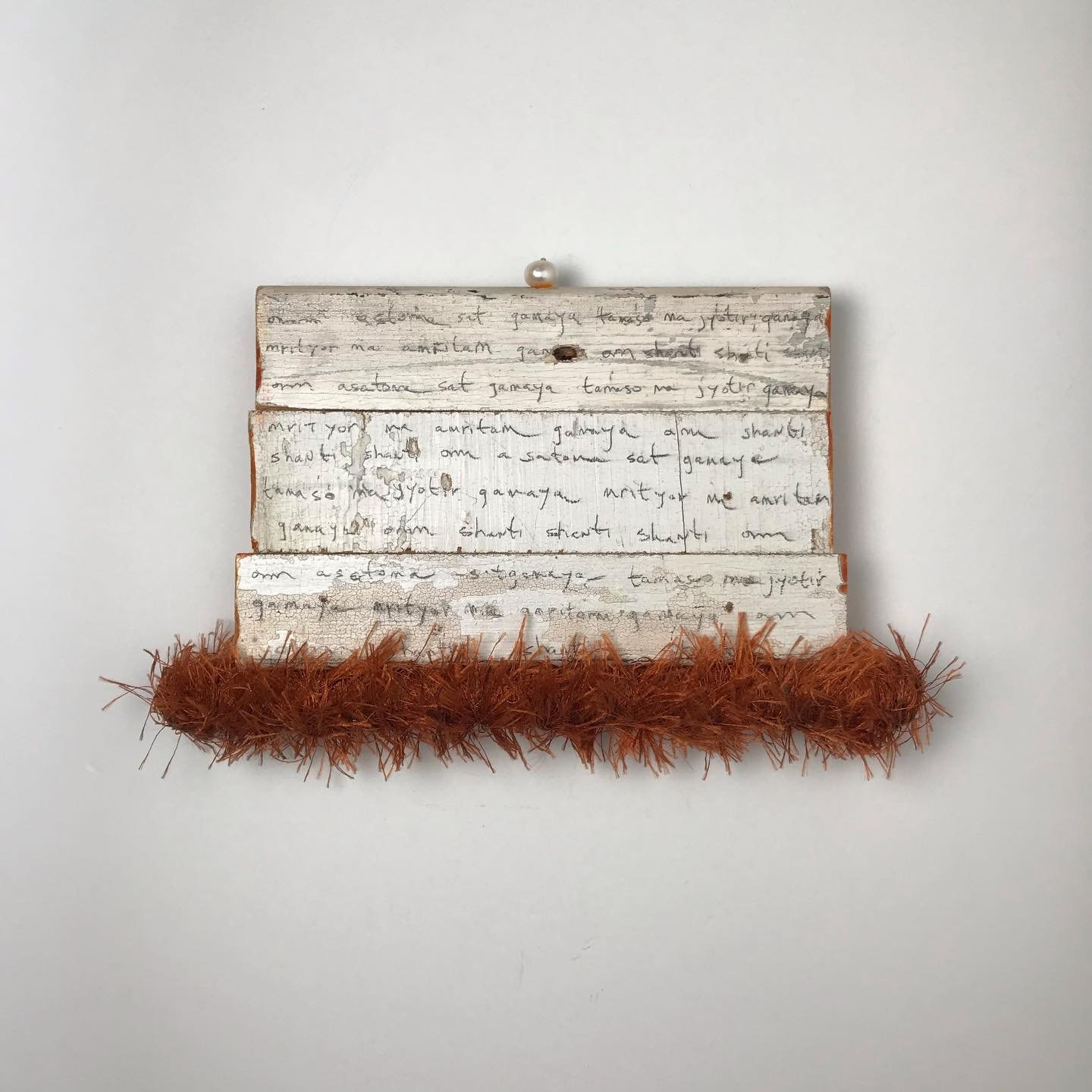 Asatoma Sadgamaya Mantra. 
5&rdquo;h x 8&rdquo;w x 1&rdquo;d 
Reclaimed wood, sealed pencil, fiber, freshwater pearl. 

Powerful ancient Vedic chant from the Upanishad. Take us from untruth to truth, from darkness to light, from death to Reality.  Pe
