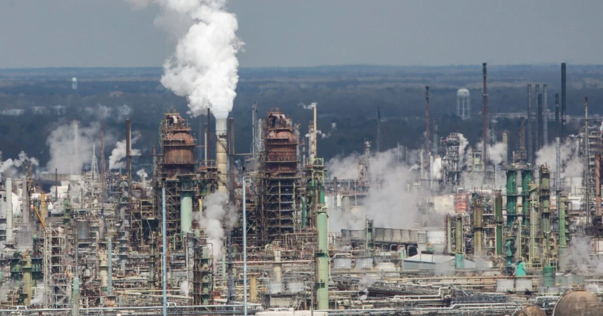 Industrial refinery with smoke stacks and vapor emissions