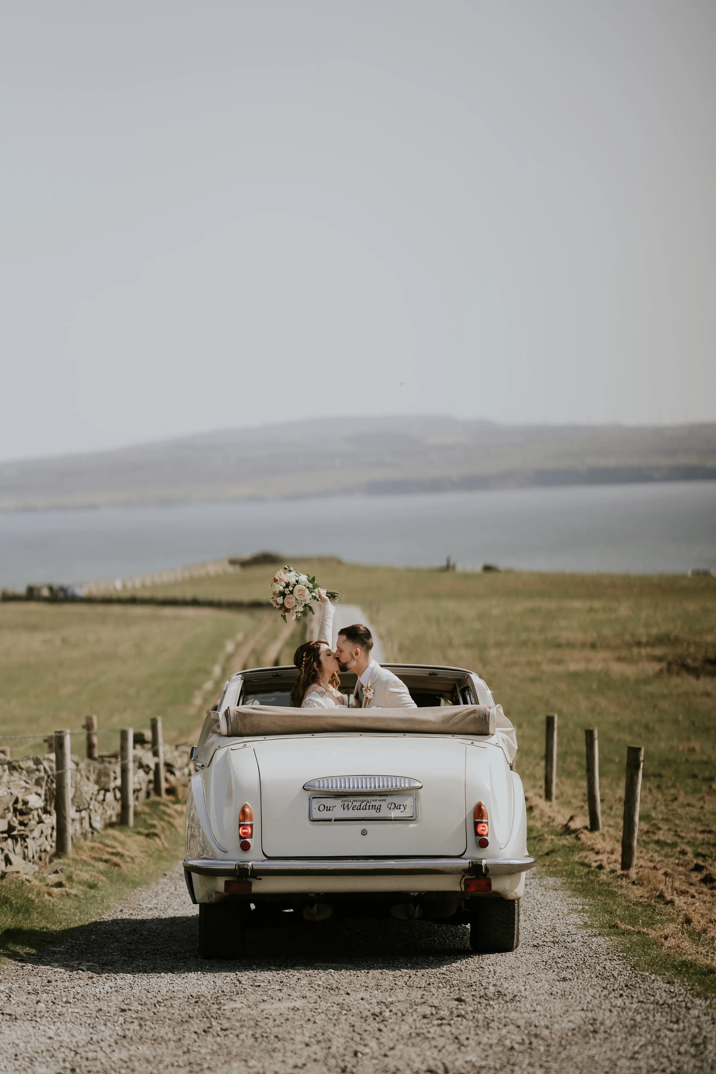Katrina and John during their wedding ceremony with the cliffs as a backdrop