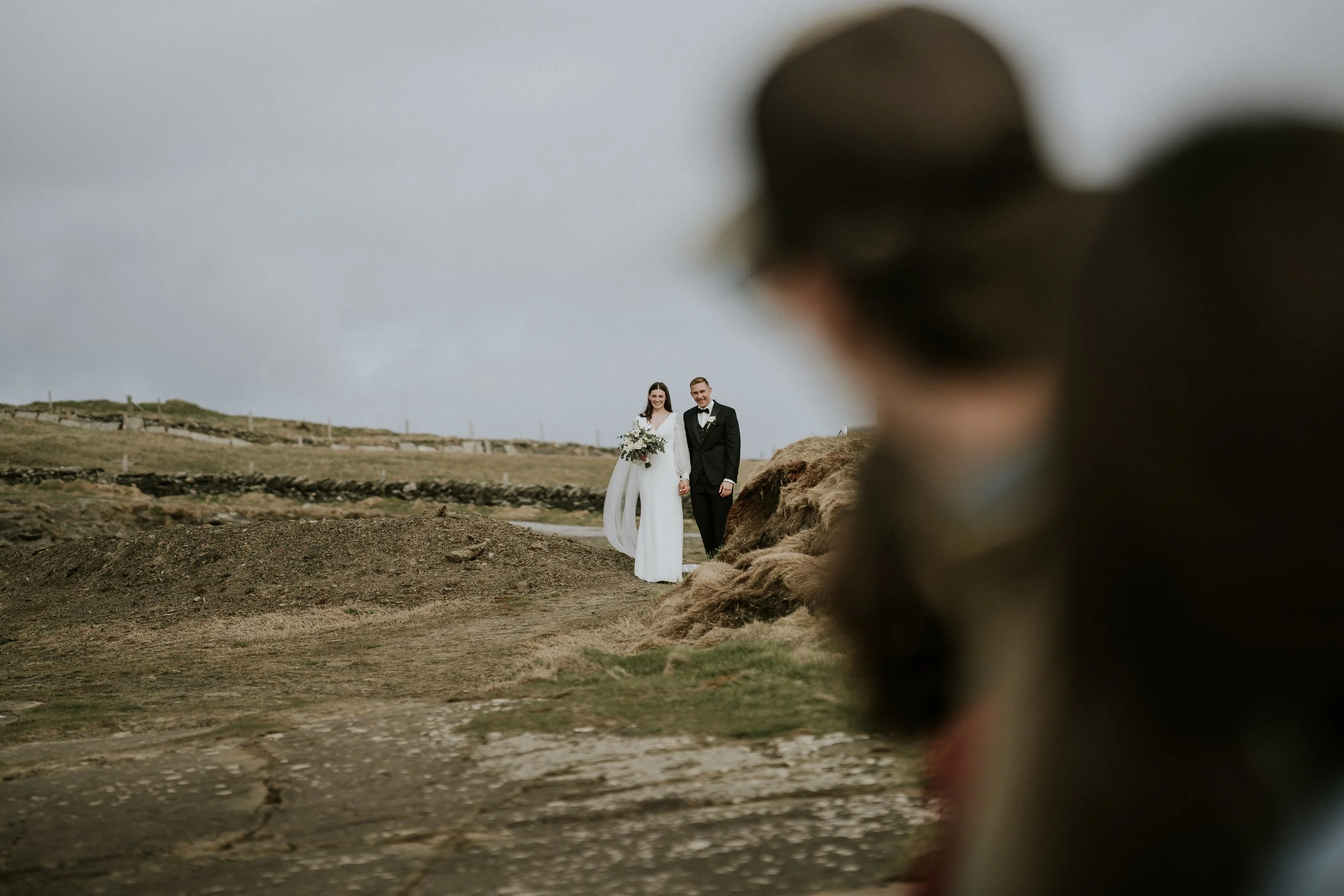 Kalee and Kristian standing at the edge of the Cliffs of Moher, Co. Clare