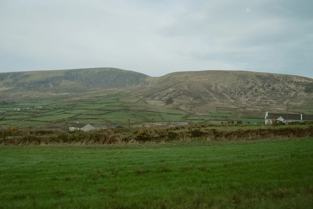 Mollie and Ryan walking together near the pier overlooking the Atlantic
