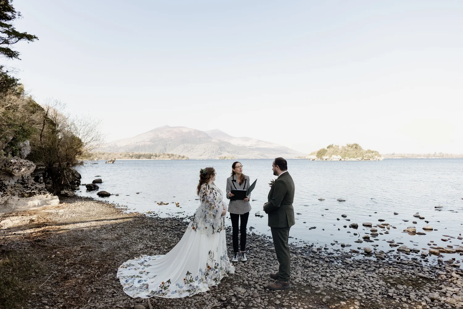 Kelli and Ethan's elopement ceremony taking place on a rocky lakeshore in Killarney National Park
