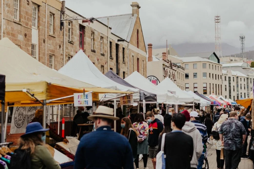 Outdoor Salamanca market, Hobart, Australia, with tents and a crowd of people.