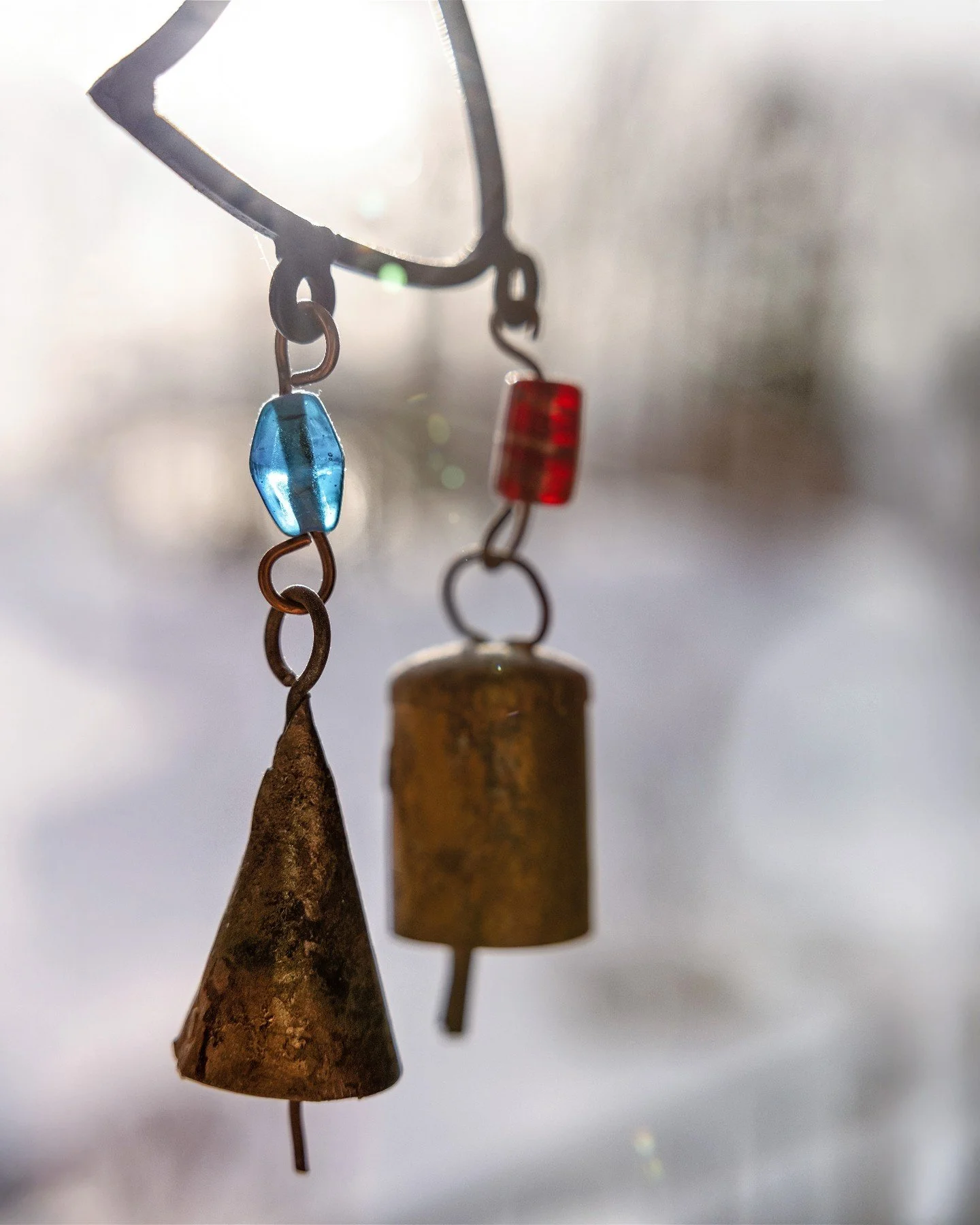 This morning the sun streamed through my window, catching the windchimes just right. January sunshine in Northern Michigan is rare, so when it shows up, I pause and take it all in.

This week&rsquo;s Project 52 challenge was asymmetry &mdash; noticin