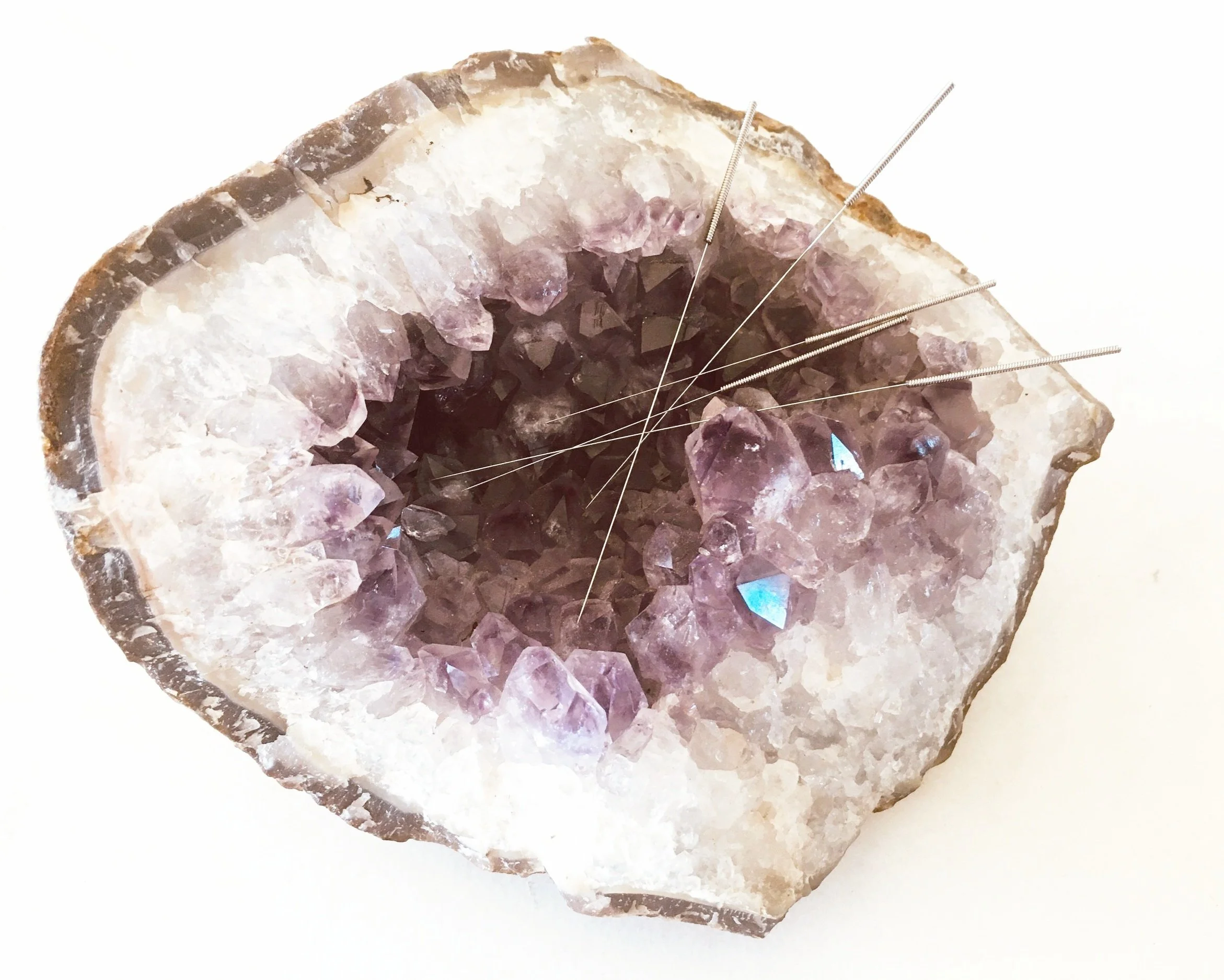 Amethyst geode crystal with acupuncture needles