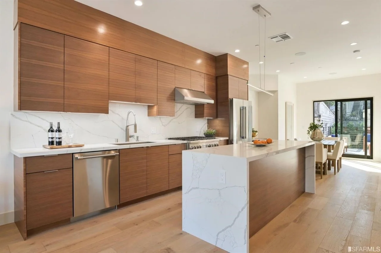 Wood cabinetry and a stone waterfall island in the Mississippi Street condominium project.