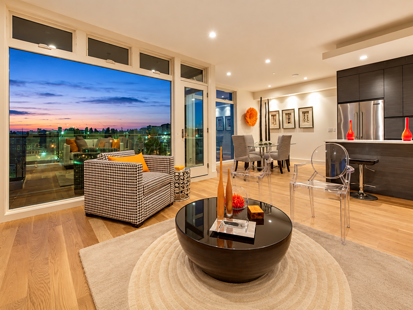 Open living and dining area with large windows and a twilight city view.