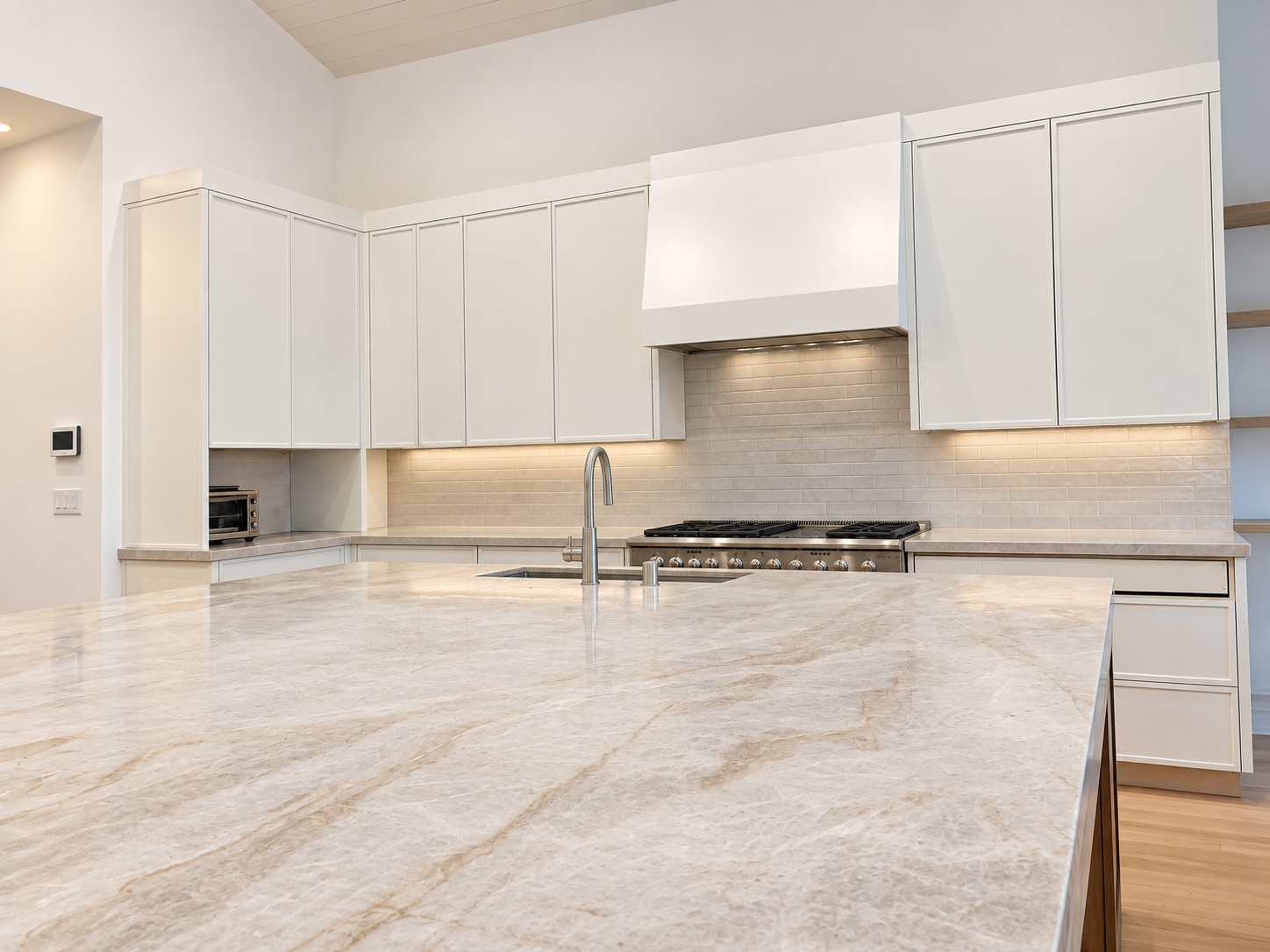 Waterfall-edge kitchen island and white cabinetry in the Warwick Street renovation.