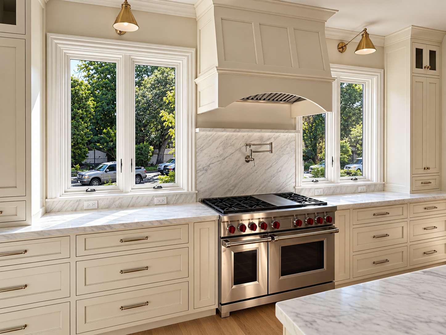 Kitchen range wall with white cabinetry, a custom hood, and large windows.