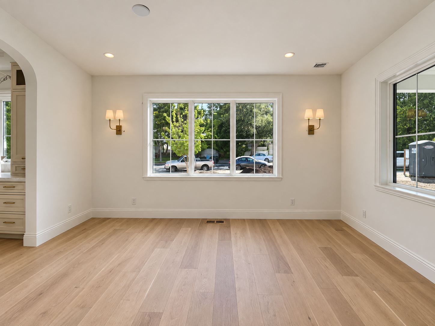 Dining room with wood floors, recessed lighting, and a large picture window.