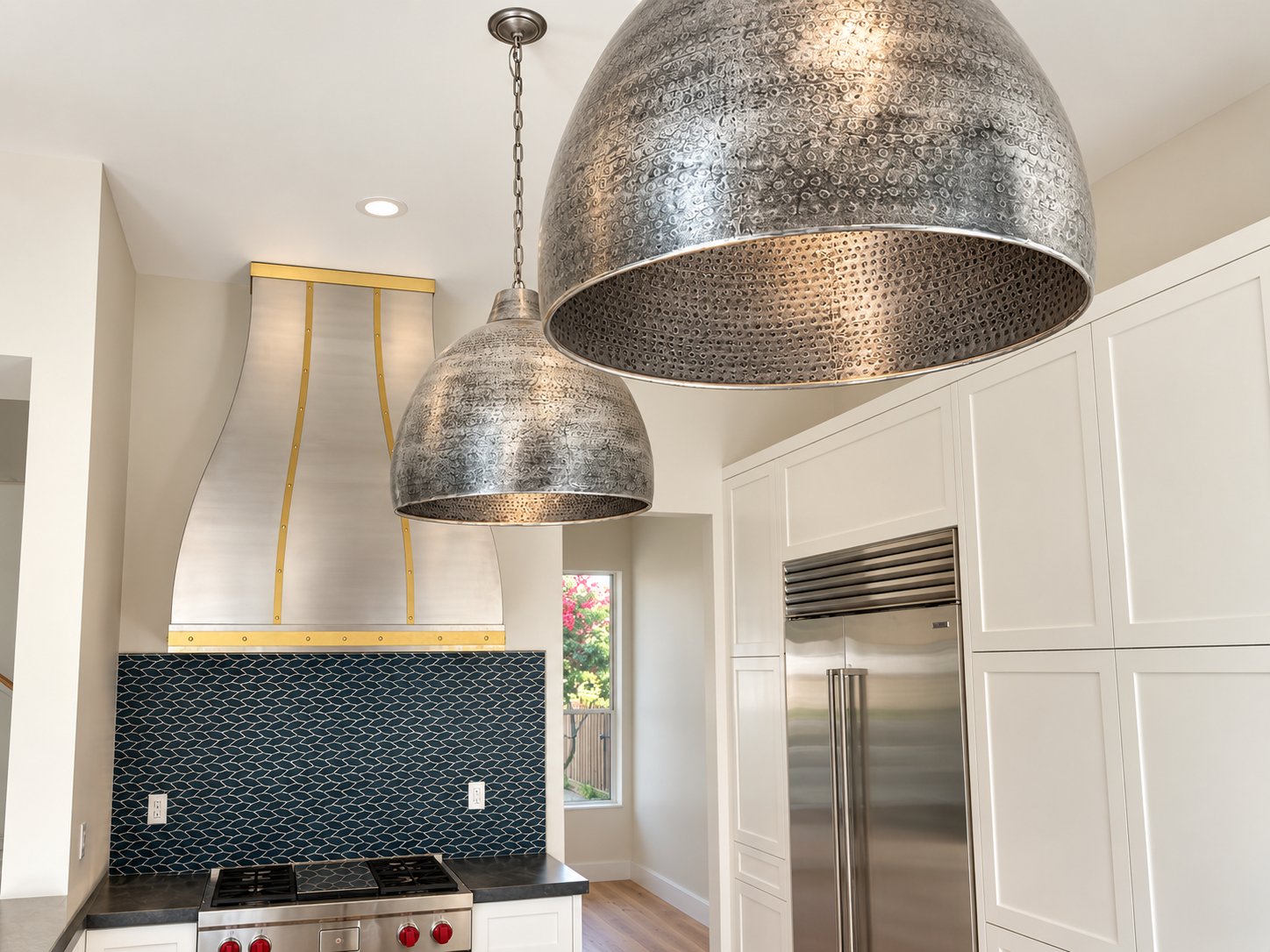 Metal pendant lights above the kitchen work area in a contemporary private residence.